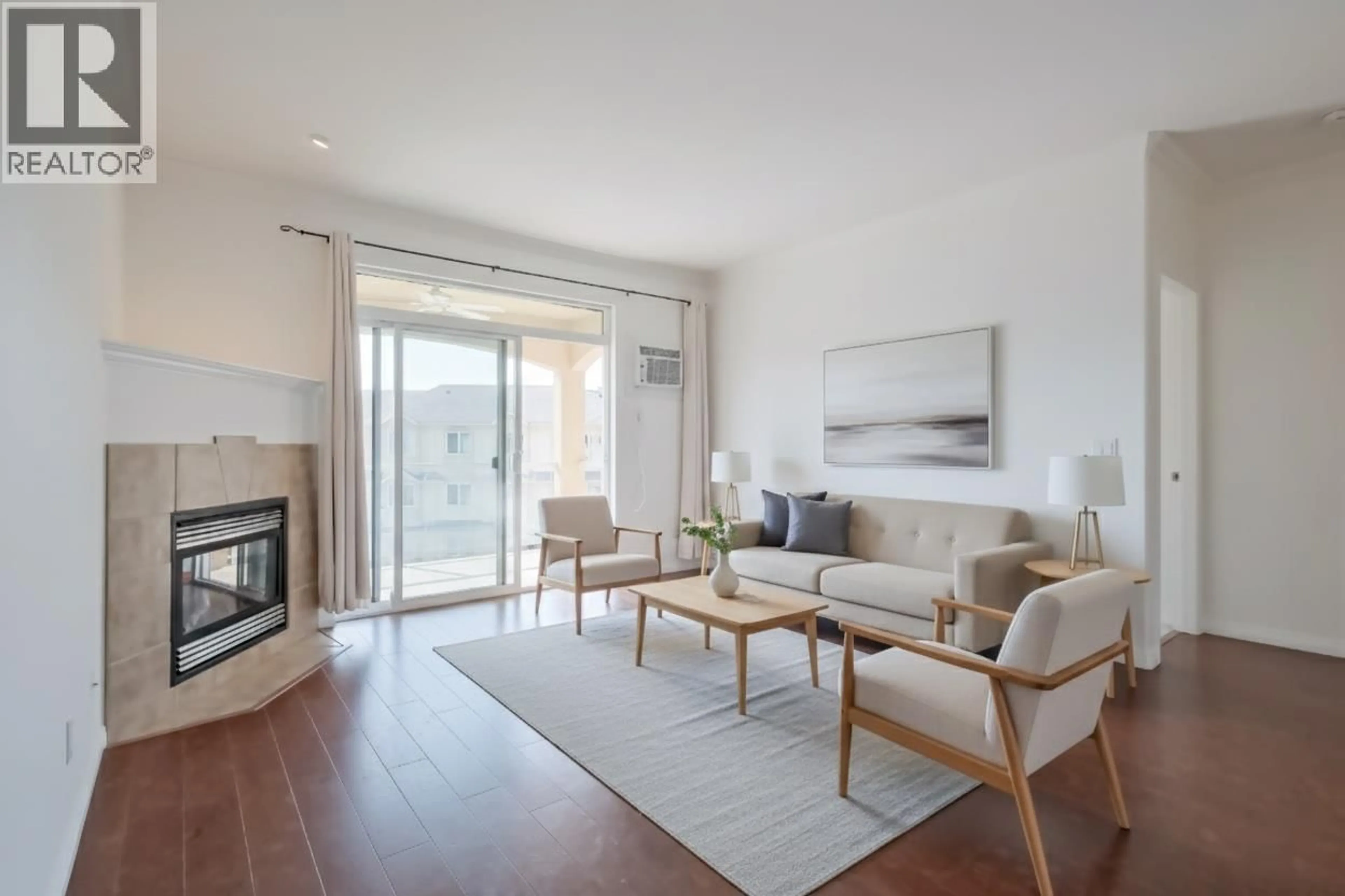 Living room with furniture, wood/laminate floor for 411 - 1962 ENTERPRISE WAY, Kelowna British Columbia V1Y9S6