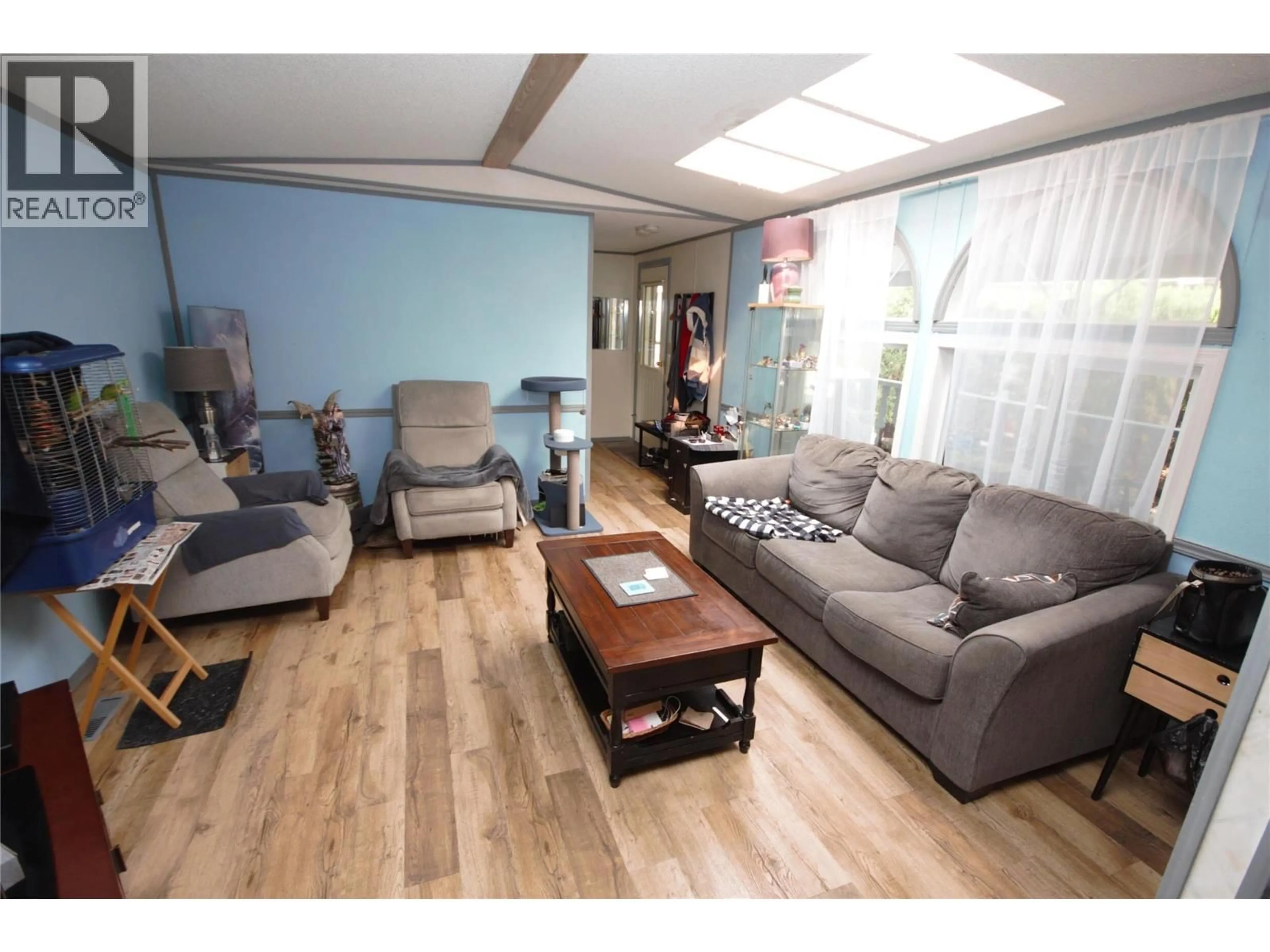 Living room with furniture, wood/laminate floor for 49 - 8487 HIGHWAY 97 OTHER, Oliver British Columbia V0H1T2