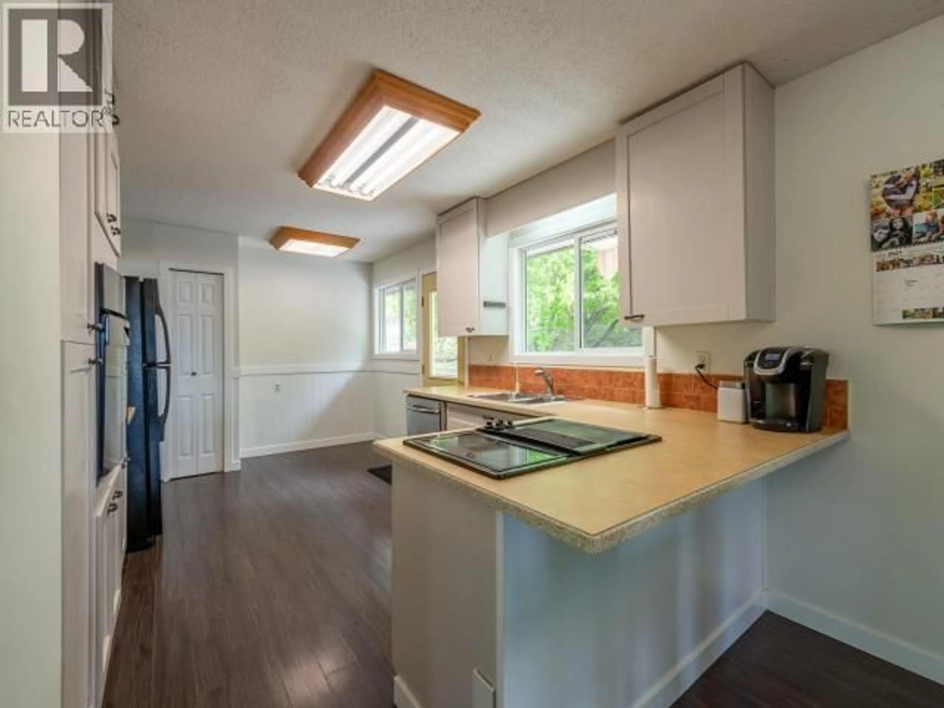 Open concept kitchen, wood/laminate floor for 525 GARDEN TERRACE, Kamloops British Columbia V2C1J4