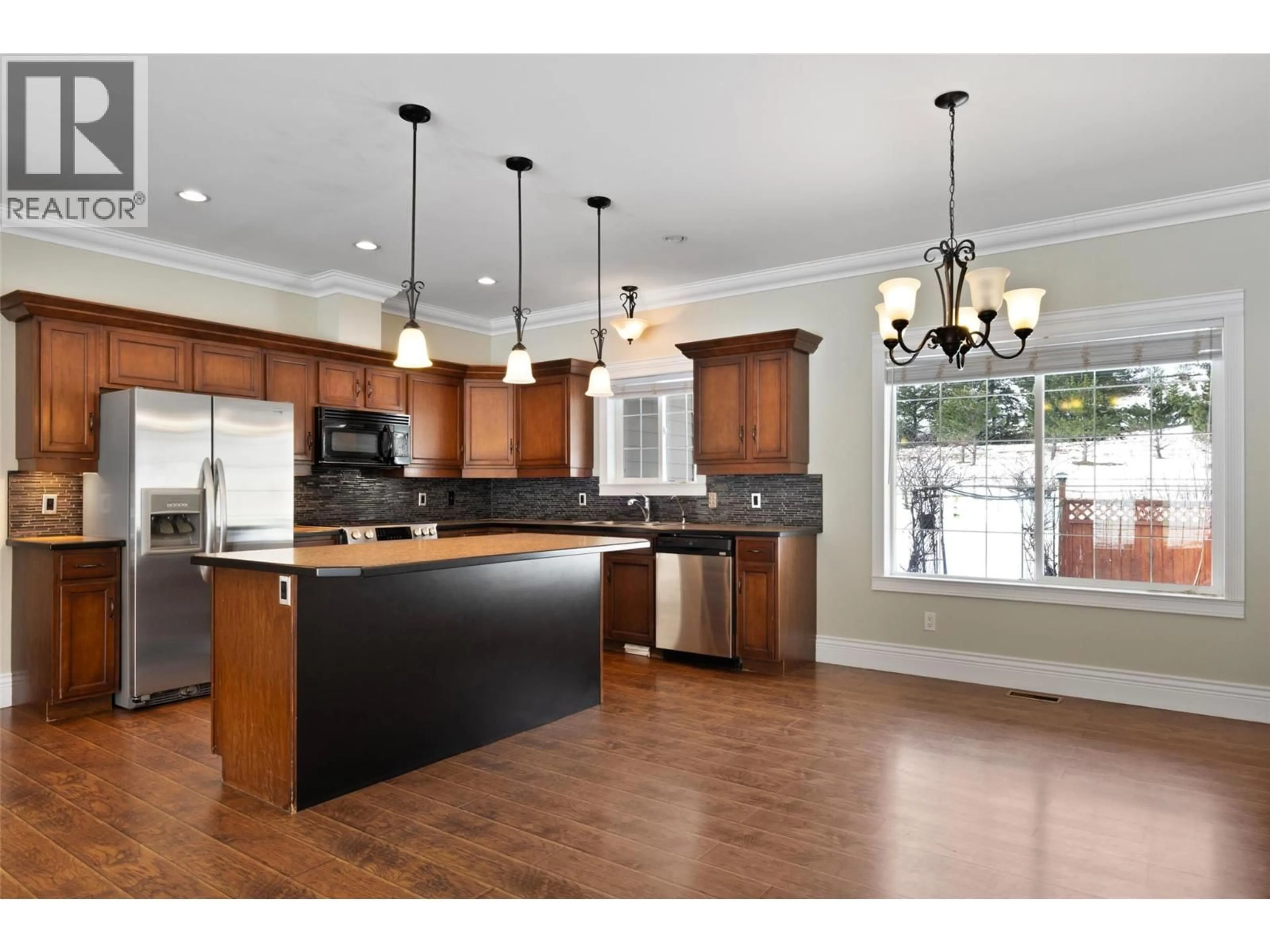 Open concept kitchen, wood/laminate floor for 1027 SALMON RIVER ROAD, Salmon Arm British Columbia V1E3G3