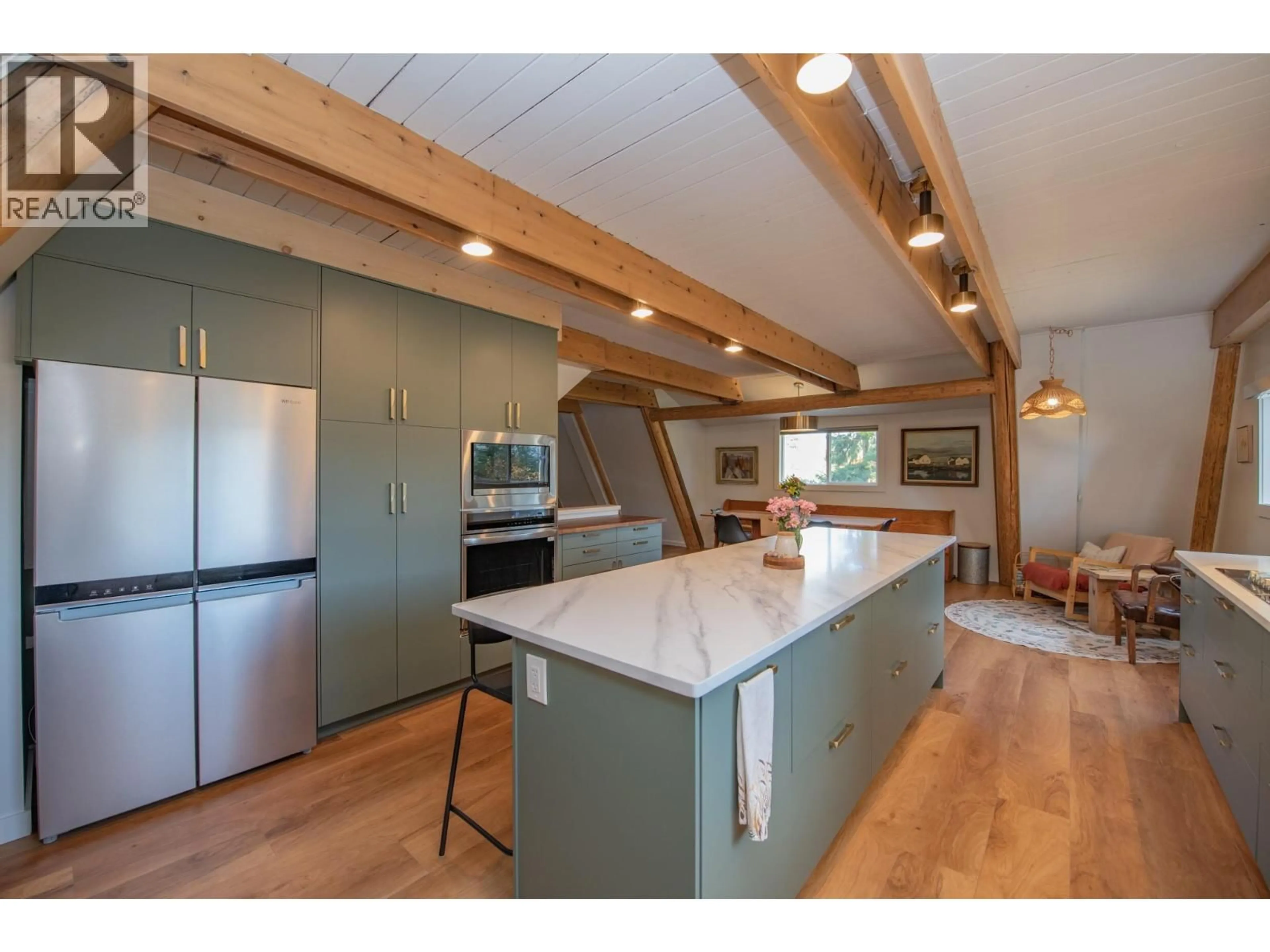 Open concept kitchen, wood/laminate floor for 2180 CATT AVENUE, Lumby British Columbia V0E2G0