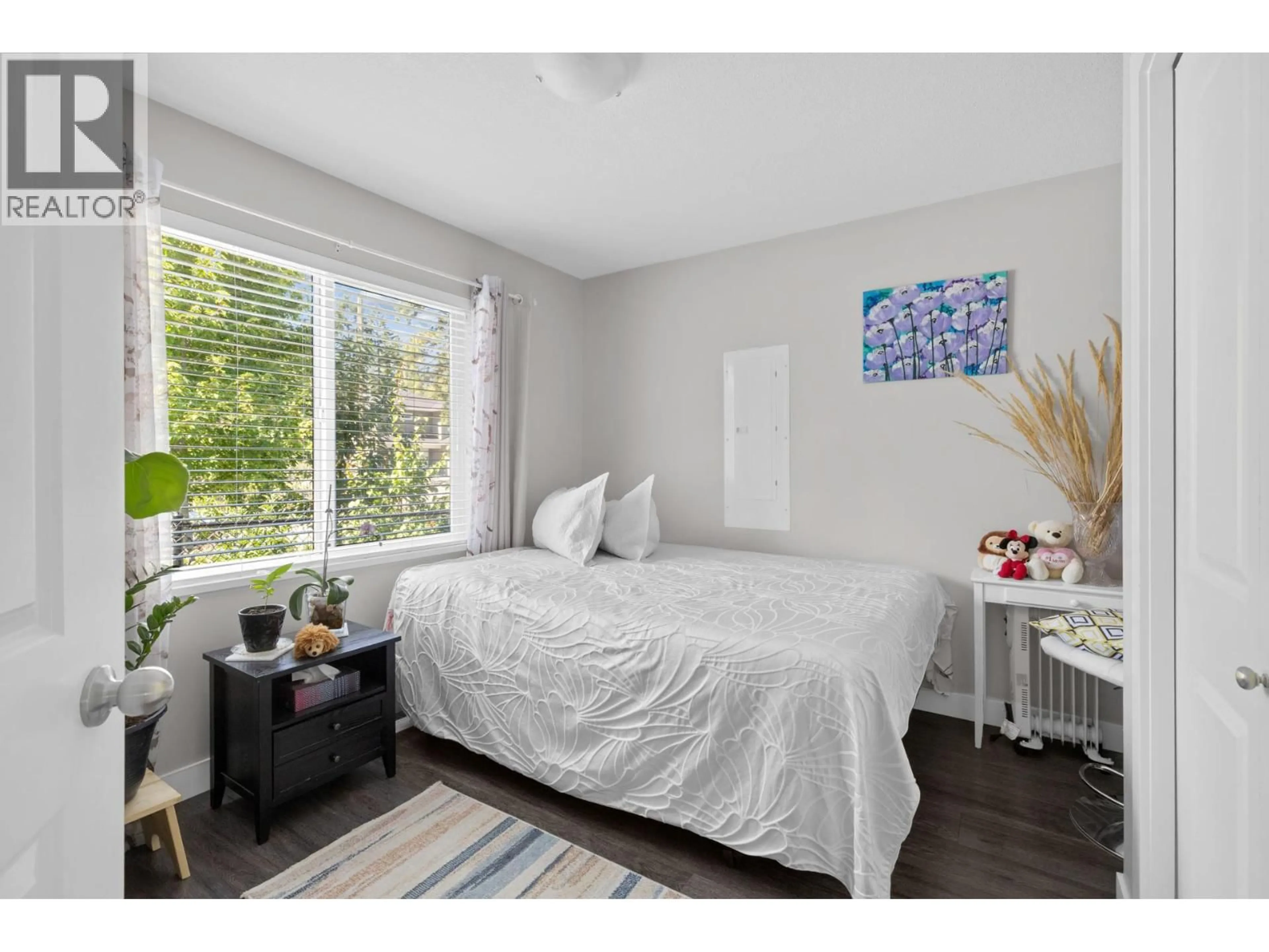 Bedroom with bed, wood/laminate floor for 690 MUIR ROAD, Kelowna British Columbia V1Z3W2