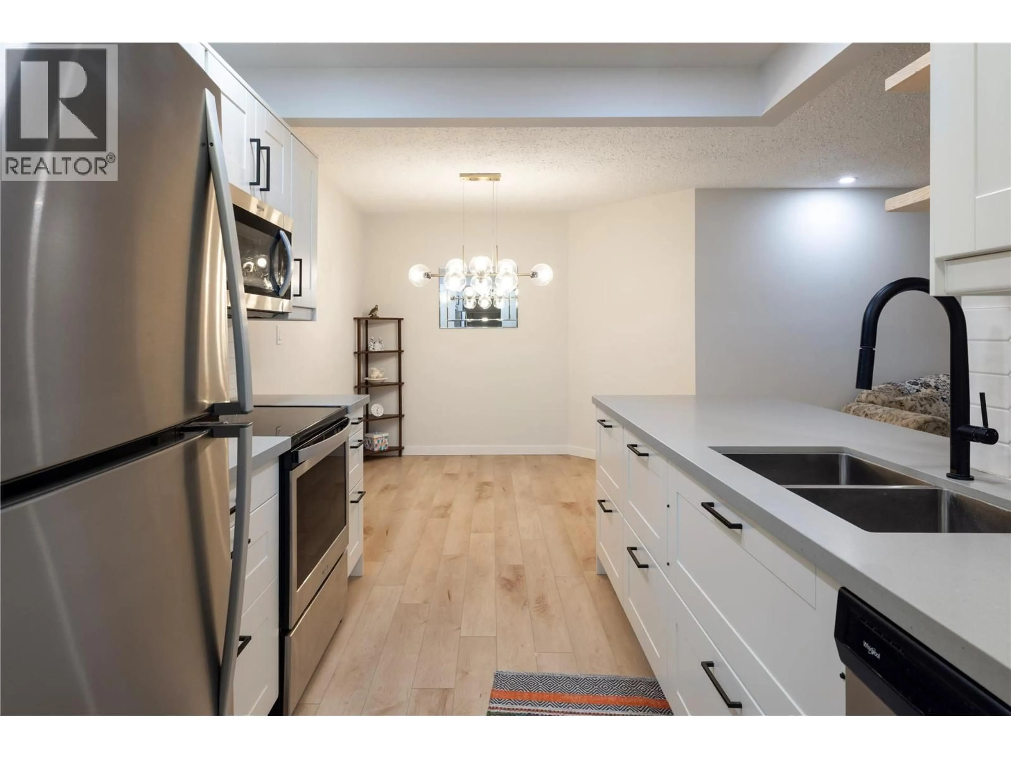 Open concept kitchen, wood/laminate floor for 110 - 1801 32 STREET, Vernon British Columbia V1T5K4