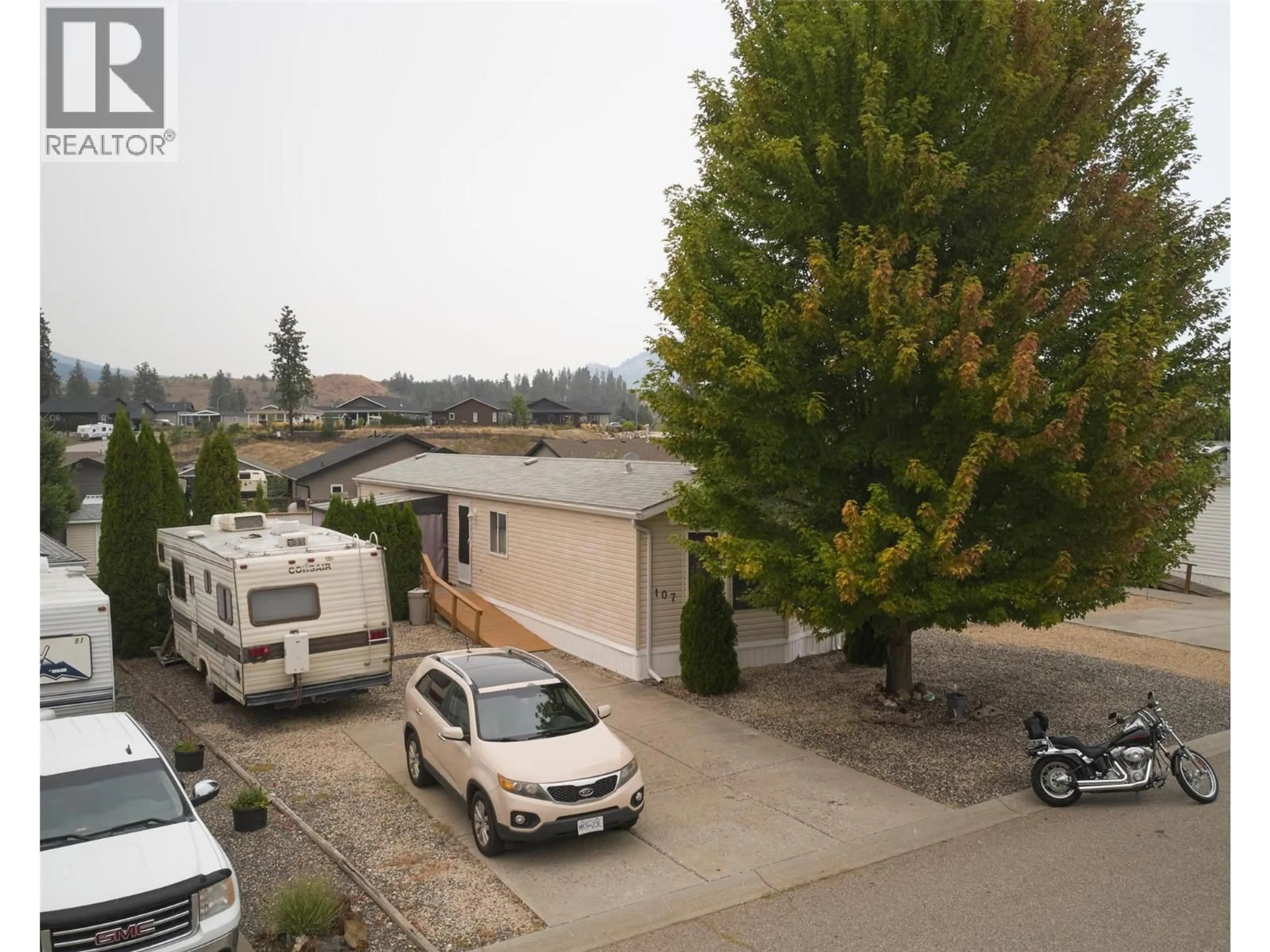 A pic from outside/outdoor area/front of a property/back of a property/a pic from drone, street for 107 - 9510 97N HIGHWAY, Vernon British Columbia V1H1R8