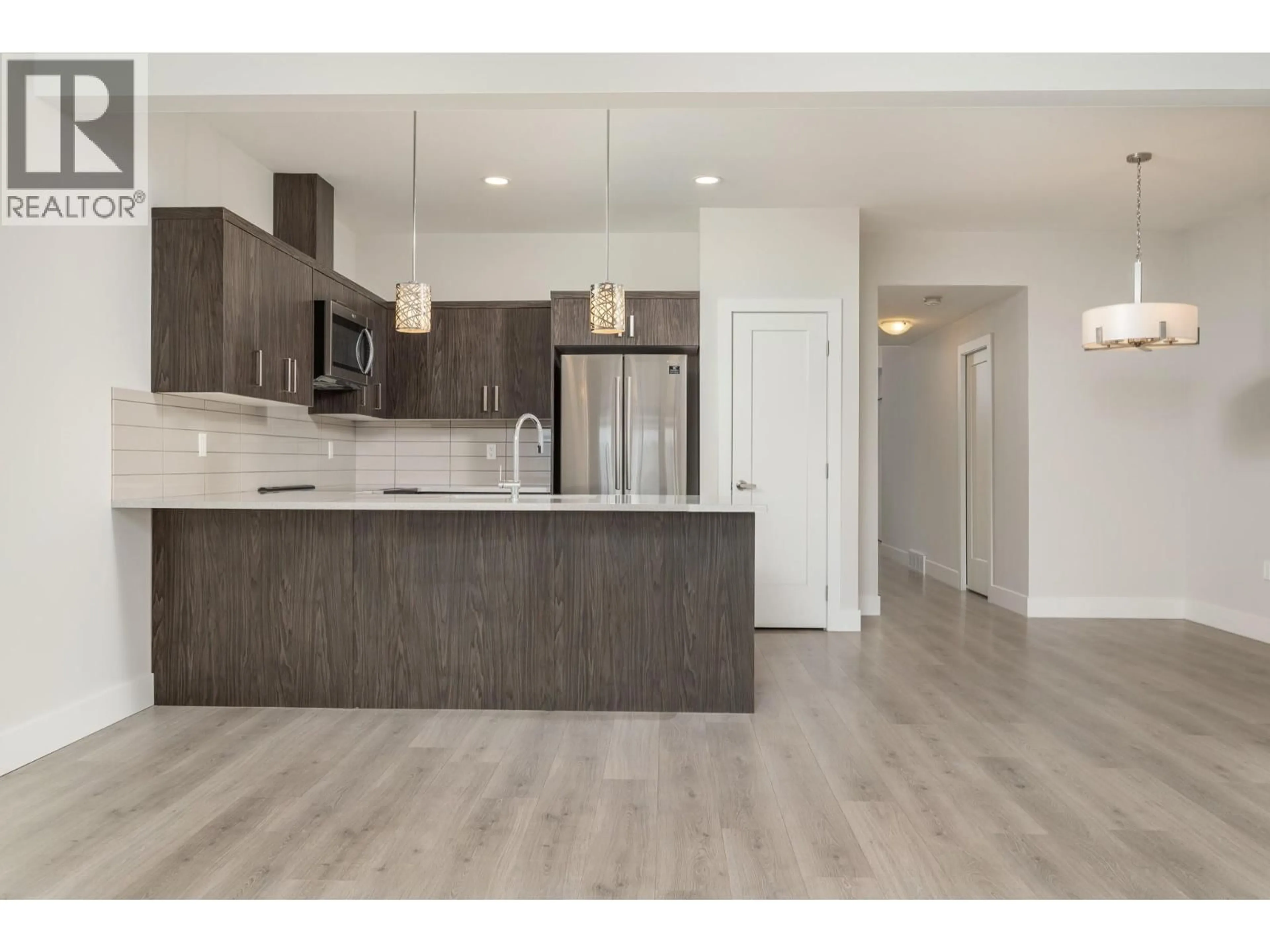 Open concept kitchen, wood/laminate floor for 97 - 933 MT ROBSON PLACE, Vernon British Columbia V1B4G4
