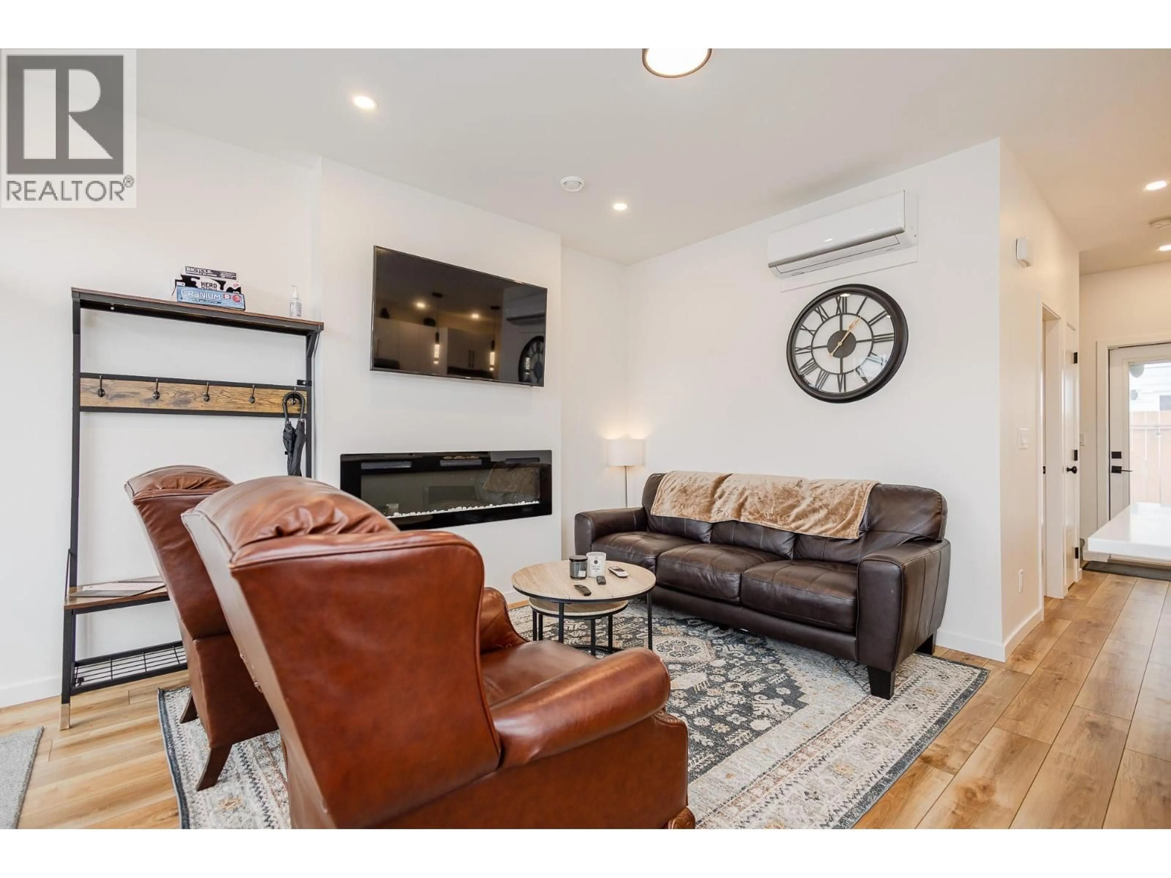 Living room with furniture, wood/laminate floor for 104 - 169 MAPLE STREET, Penticton British Columbia V2A5V4