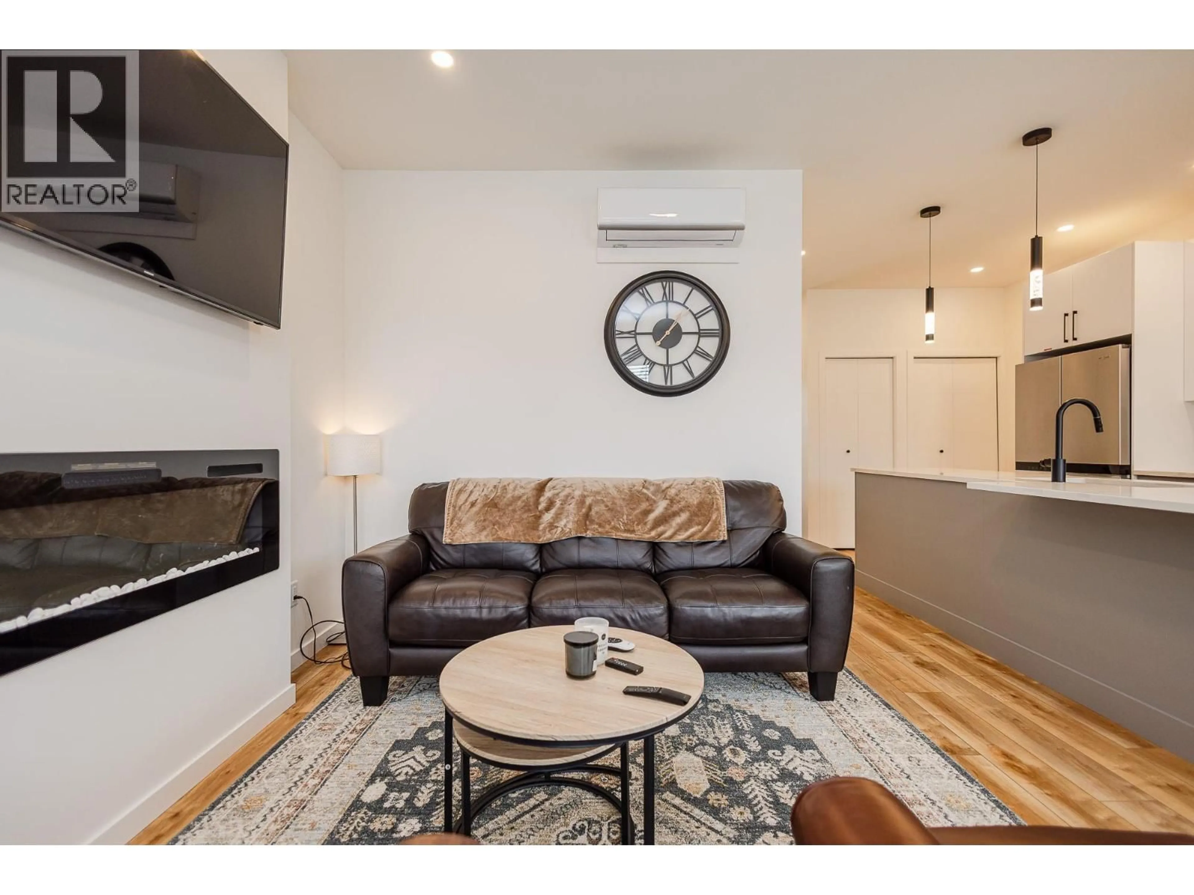 Living room with furniture, wood/laminate floor for 104 - 169 MAPLE STREET, Penticton British Columbia V2A5V4