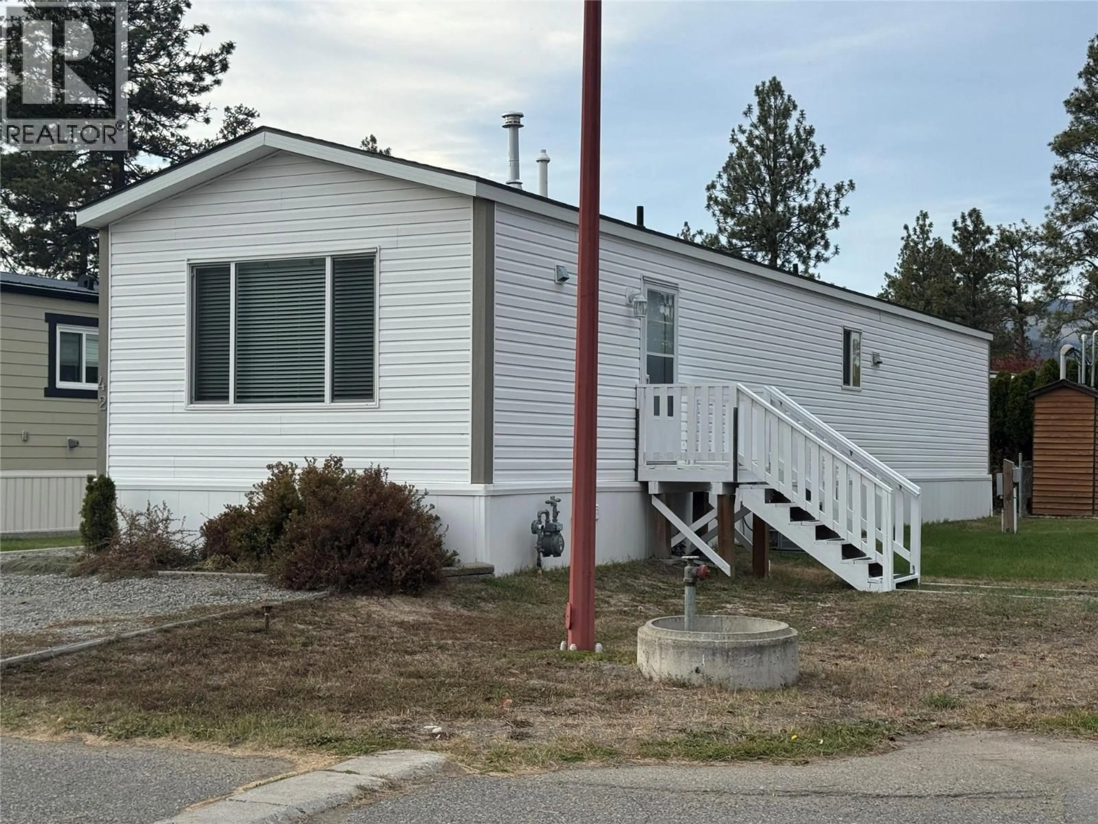 Home with vinyl exterior material, street for 42 - 254 8 HIGHWAY, Merritt British Columbia V1K1M7