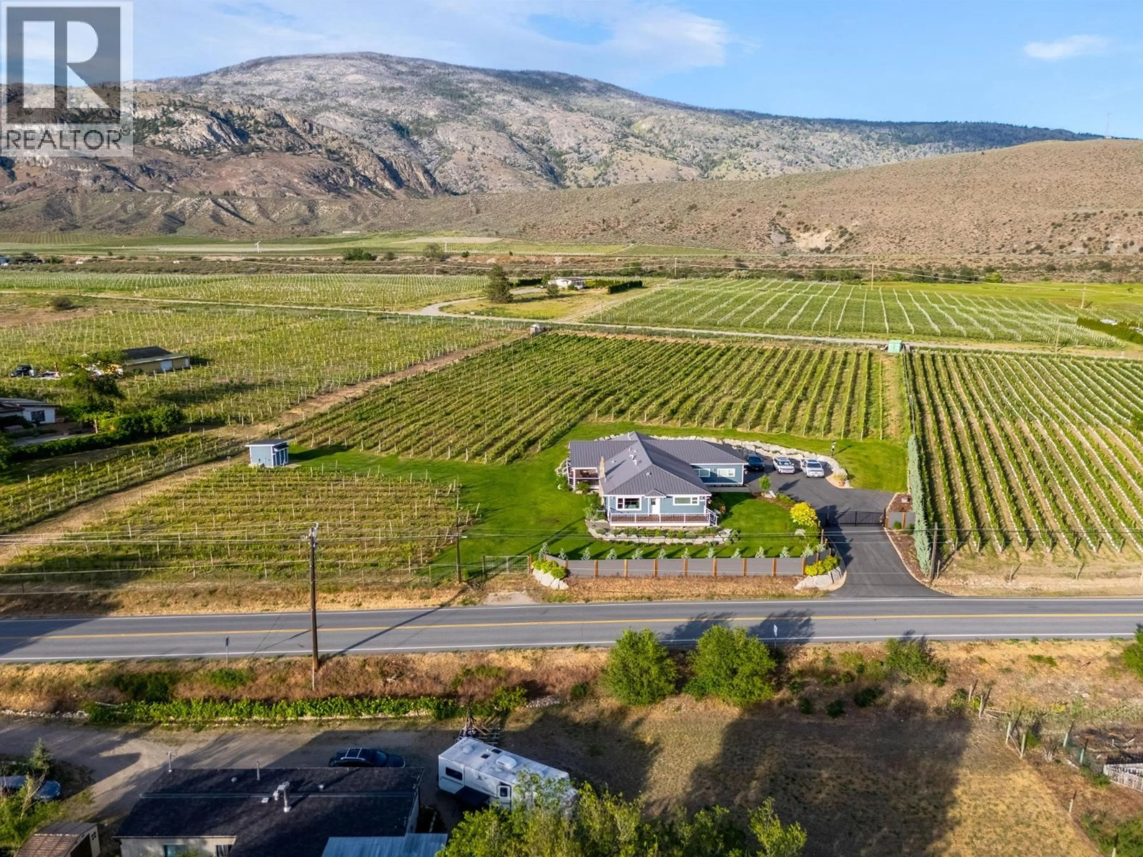 A pic from outside/outdoor area/front of a property/back of a property/a pic from drone, mountain view for 7207 TUCELNUIT DRIVE, Oliver British Columbia V0H1T2