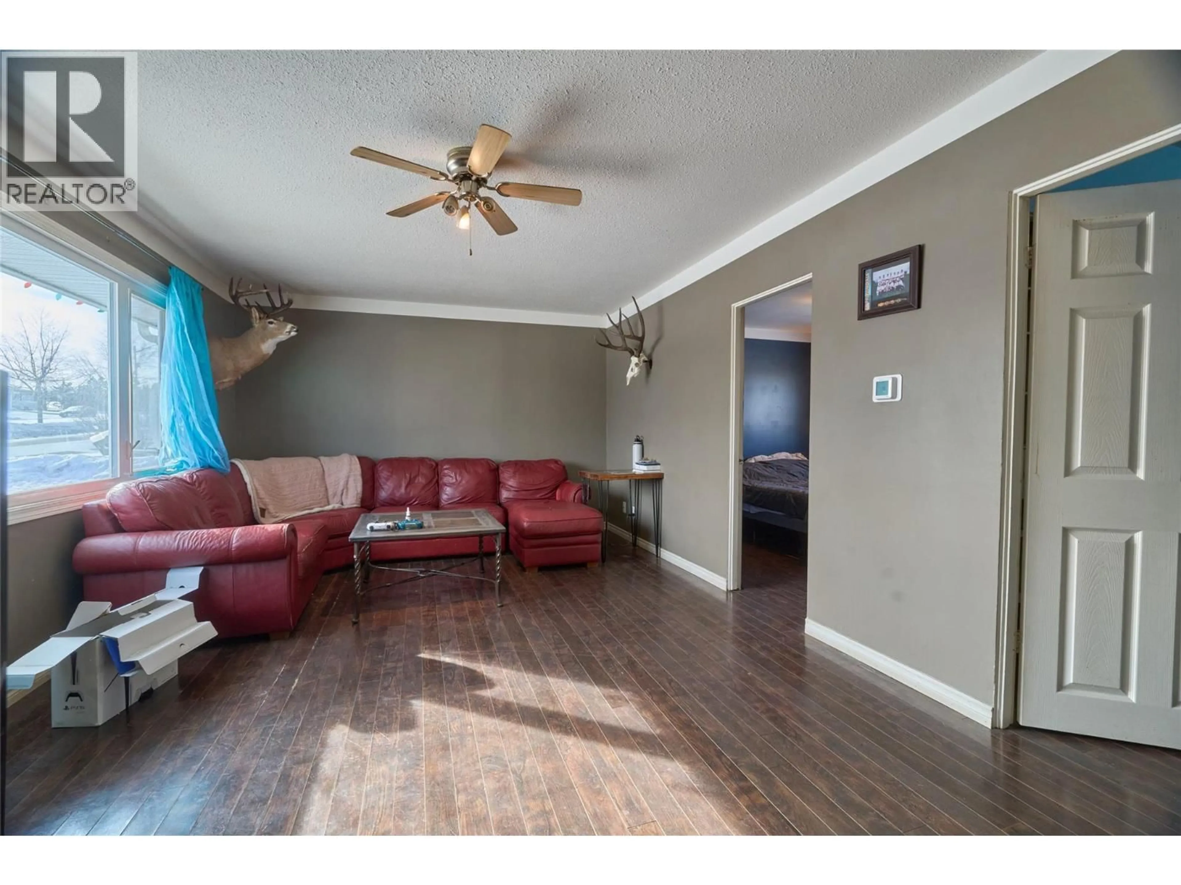 Living room with furniture, wood/laminate floor for 1608 116 AVENUE, Dawson Creek British Columbia V1G3G4