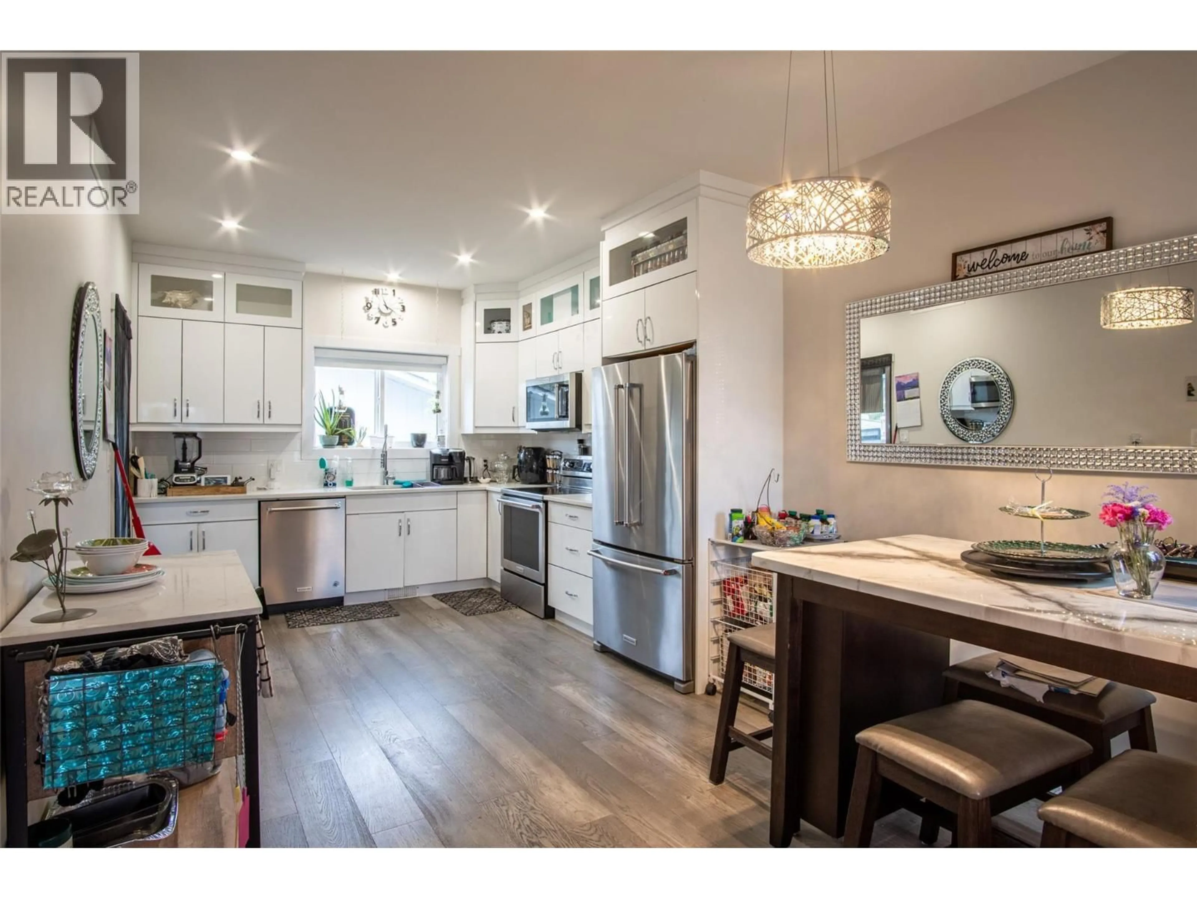 Open concept kitchen, wood/laminate floor for 136 MUGFORD ROAD, Kelowna British Columbia V1X3B3