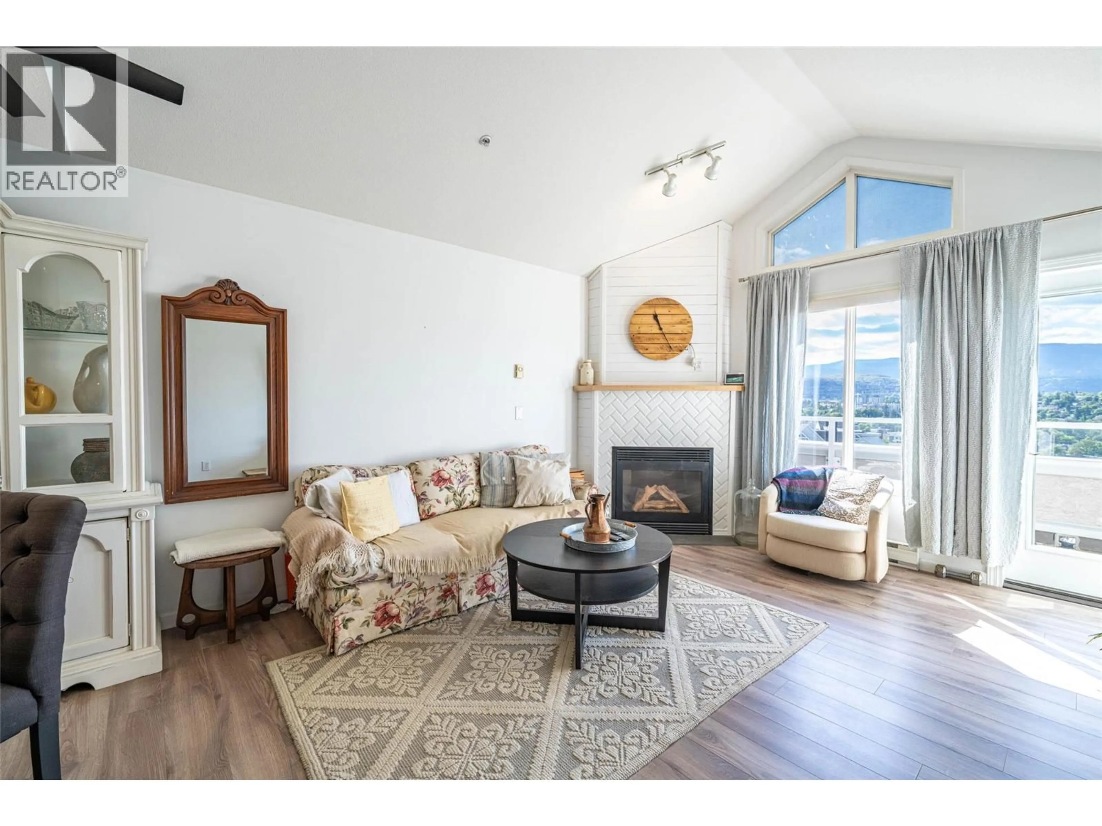 Living room with furniture, wood/laminate floor for 403 - 3320 CENTENNIAL DRIVE, Vernon British Columbia V1T9M4