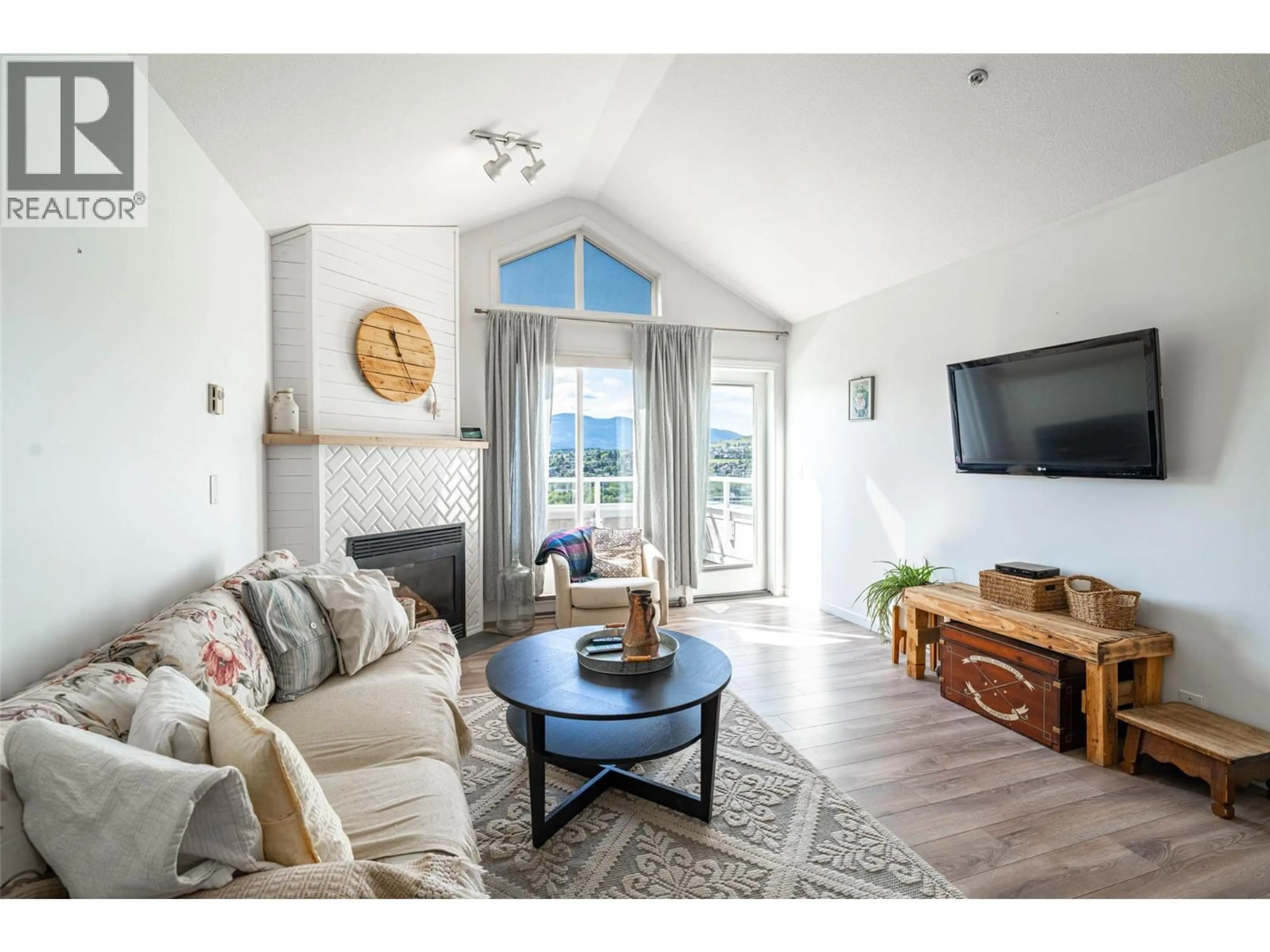 Living room with furniture, wood/laminate floor for 403 - 3320 CENTENNIAL DRIVE, Vernon British Columbia V1T9M4