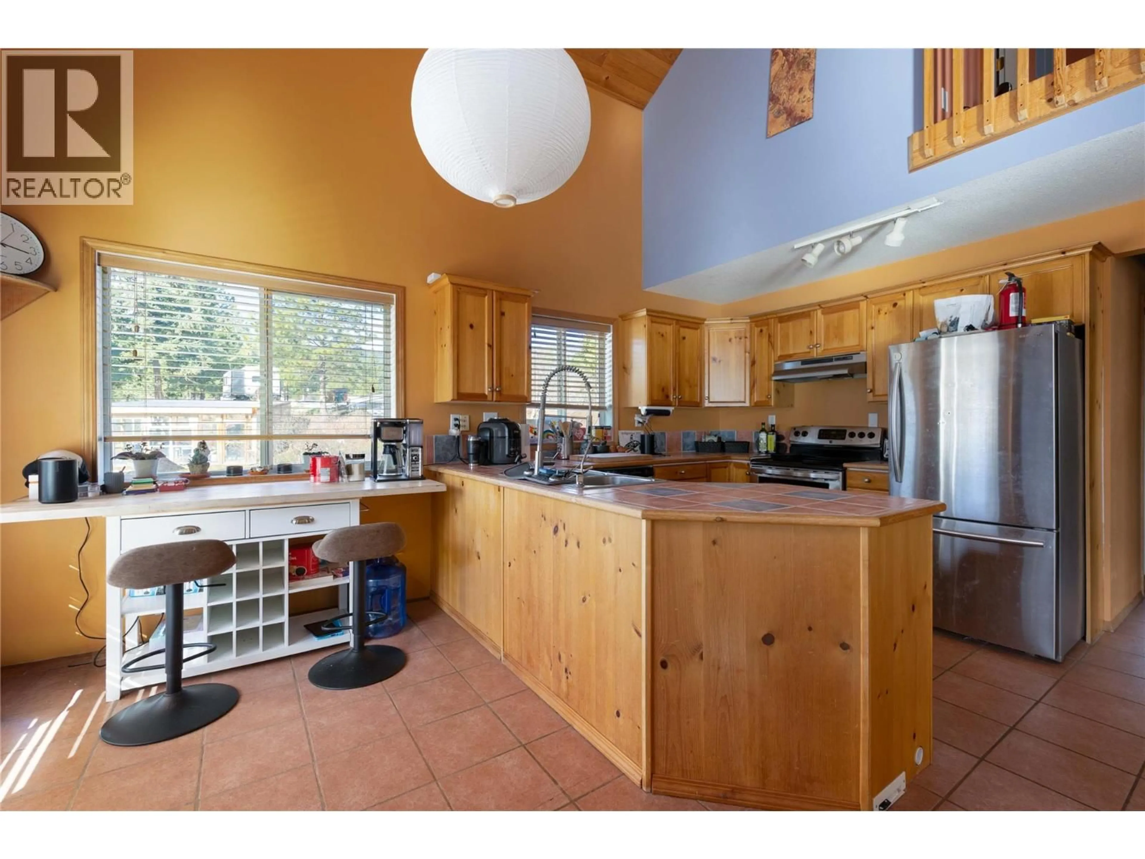 Open concept kitchen, wood/laminate floor for 3230 SALMON RIVER ROAD, Salmon Arm British Columbia V1E3H9