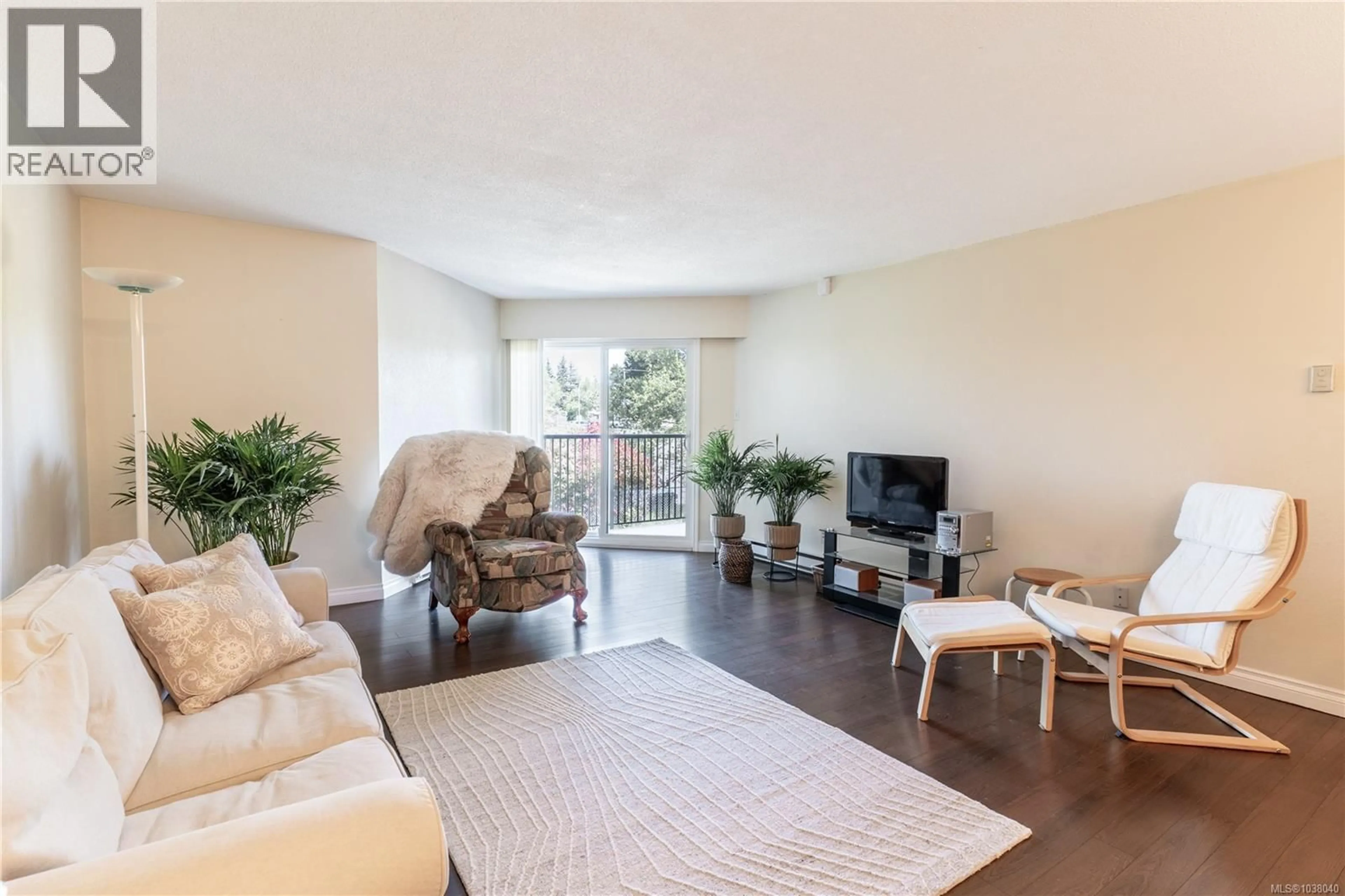 Living room with furniture, wood/laminate floor for 220 - 1870 MCKENZIE AVENUE, Saanich British Columbia V8N4X3