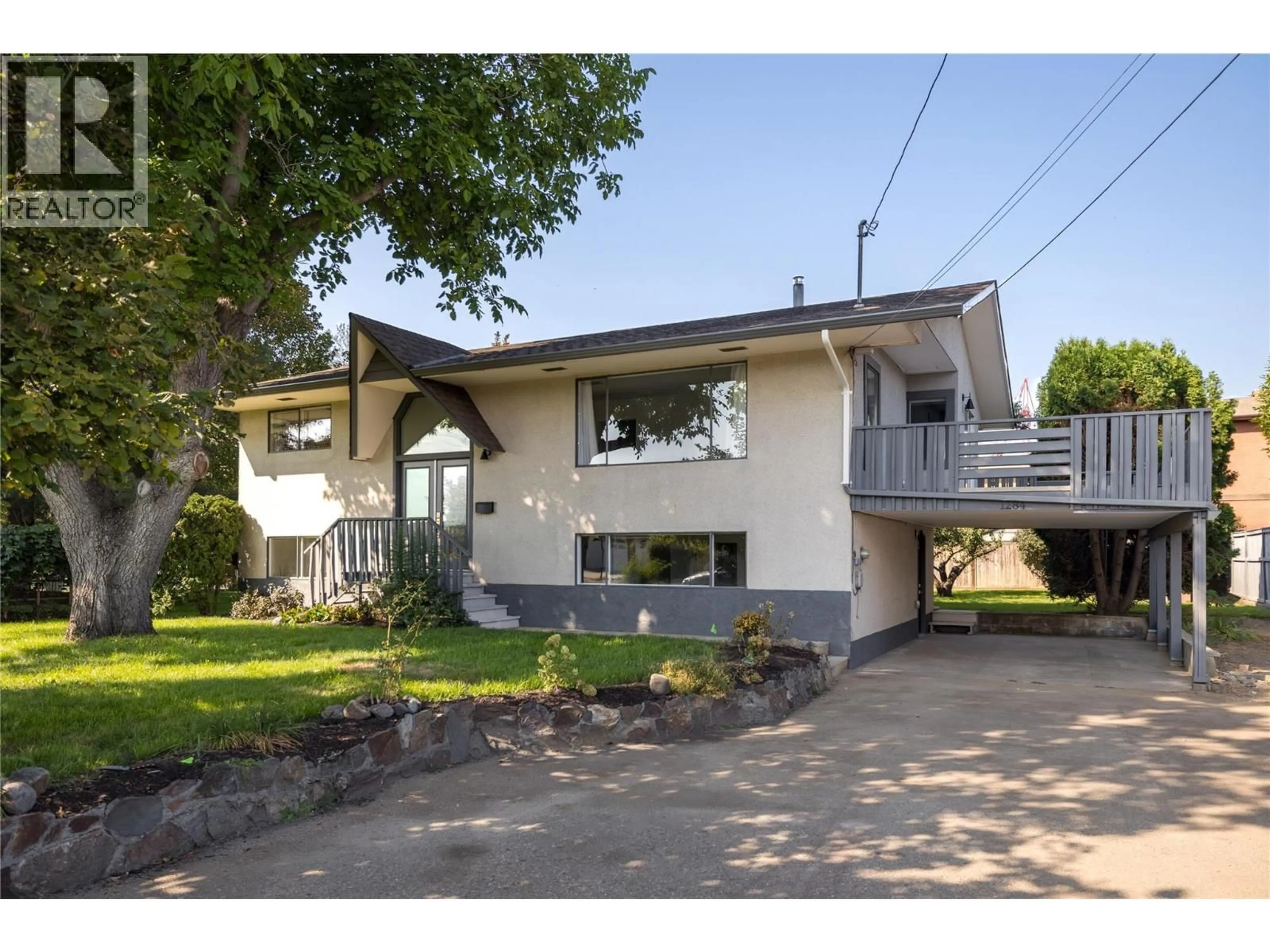 Home with vinyl exterior material, street for 1284 MCBRIDE ROAD, Kelowna British Columbia V1Y4A3