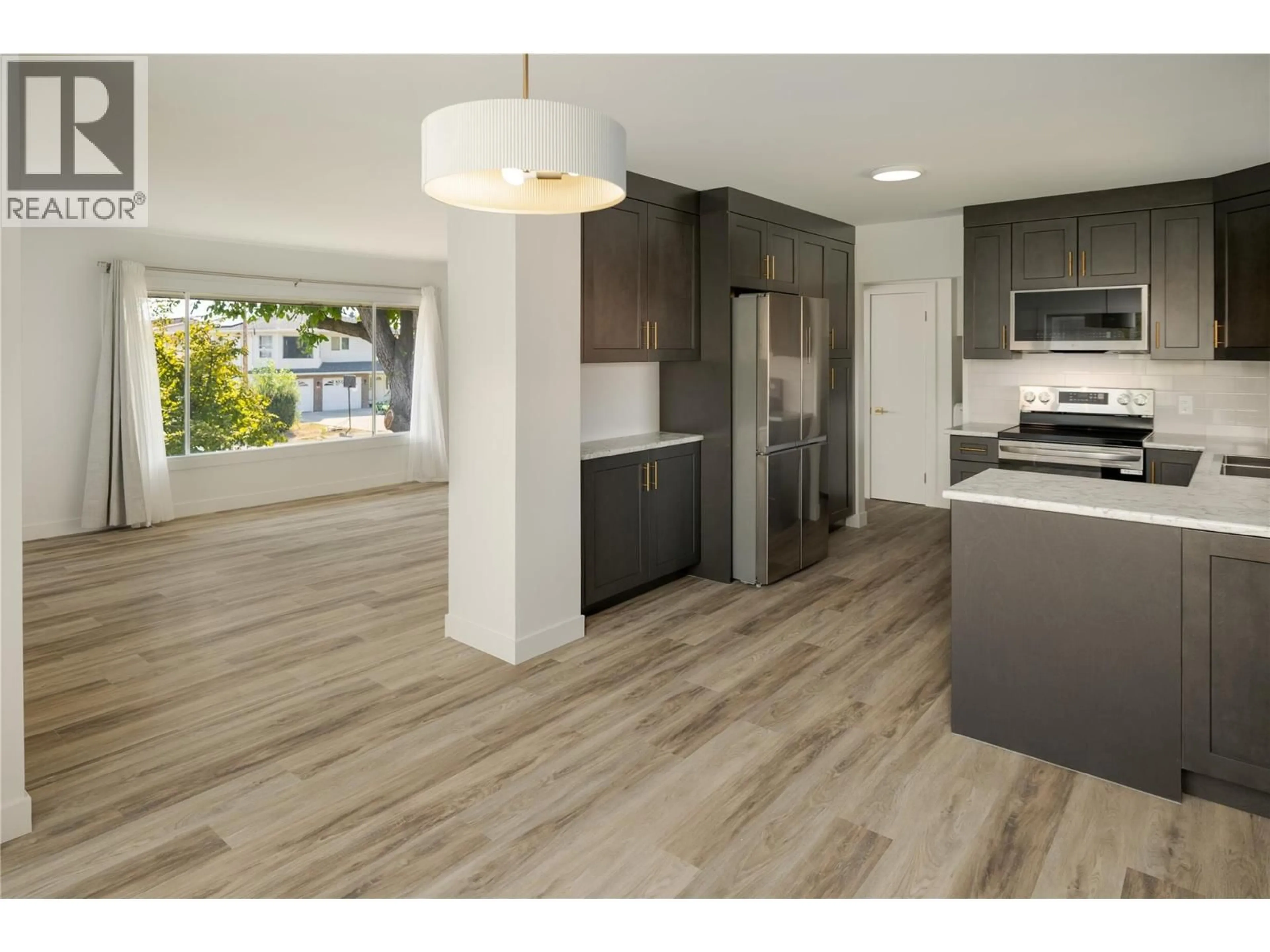 Open concept kitchen, wood/laminate floor for 1284 MCBRIDE ROAD, Kelowna British Columbia V1Y4A3