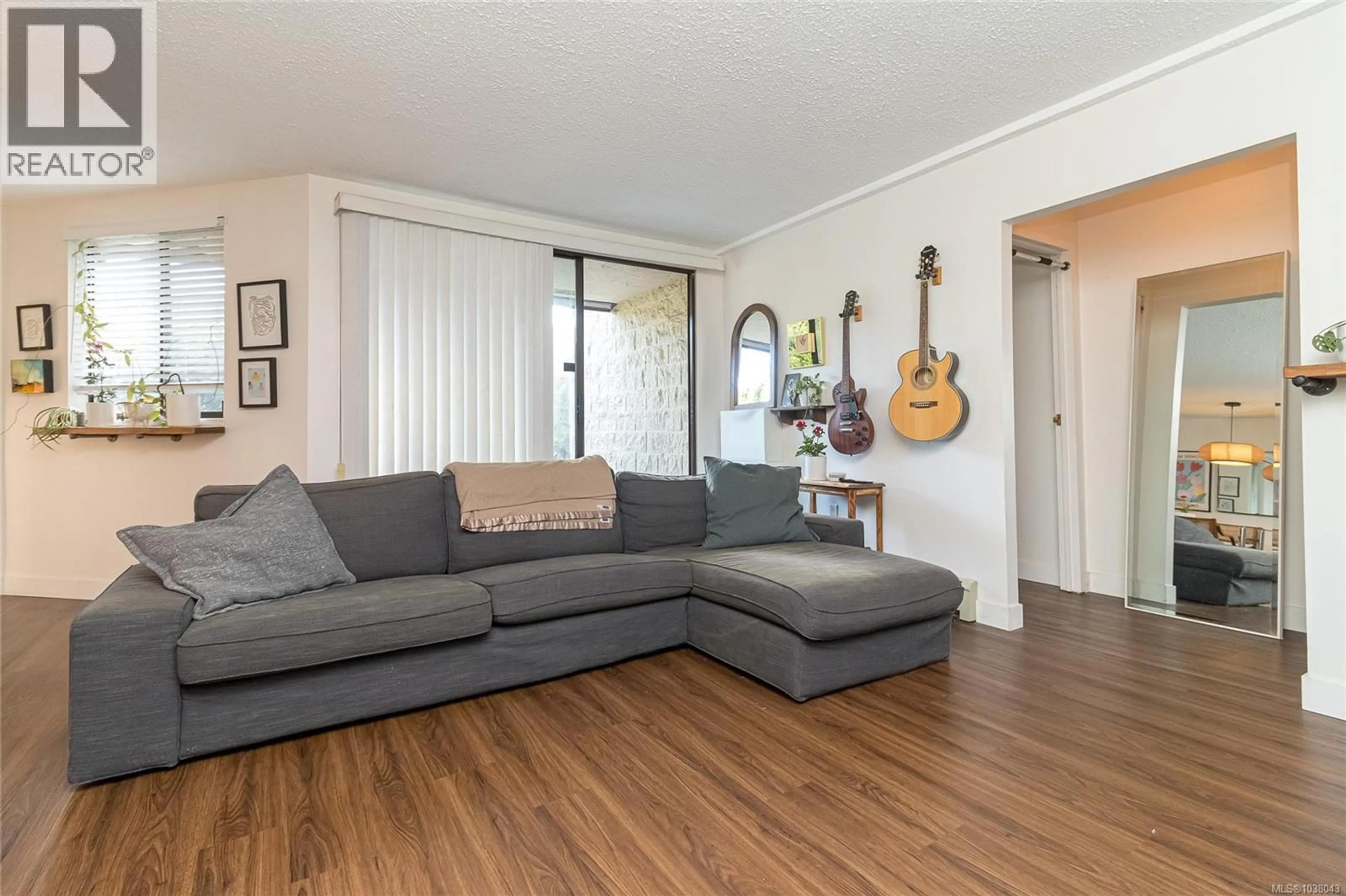 Living room with furniture, wood/laminate floor for 102 - 1745 LEIGHTON ROAD, Victoria British Columbia V8R6R6