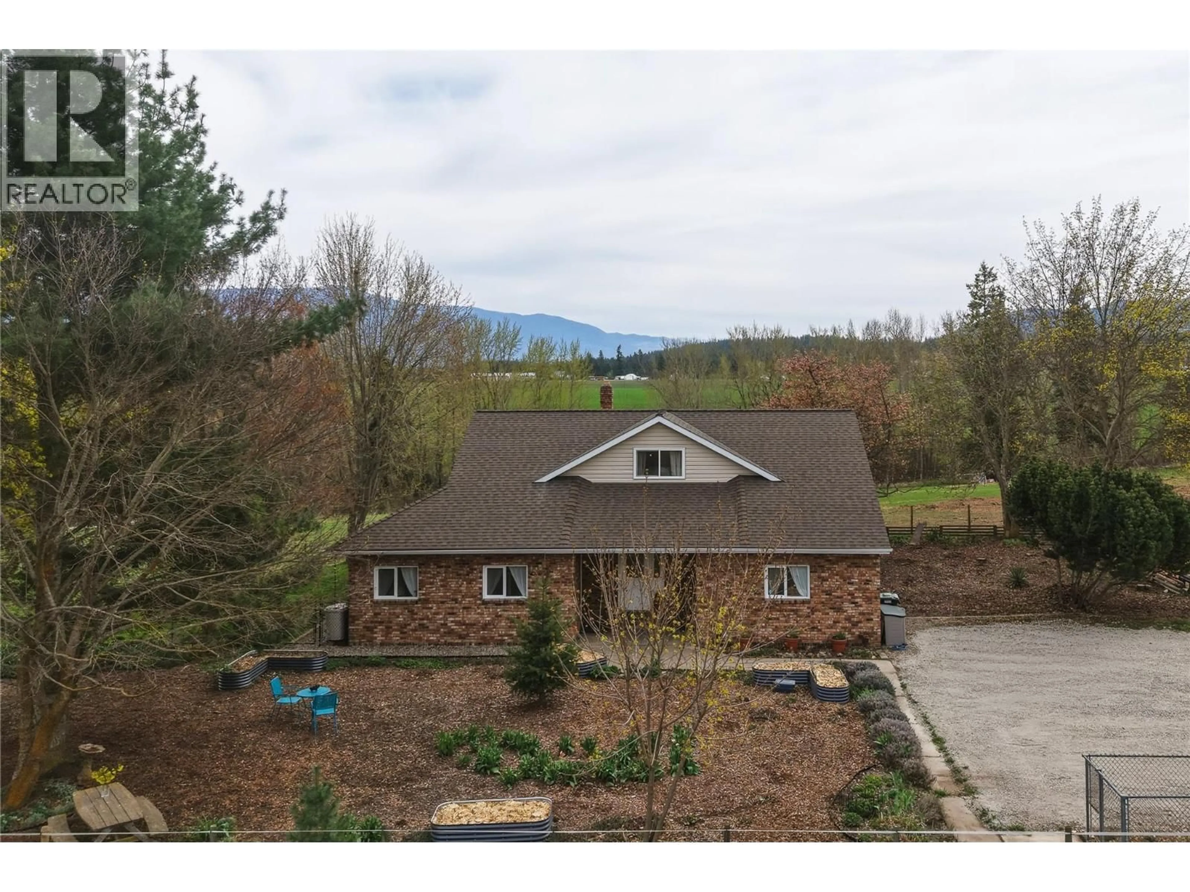 A pic from outside/outdoor area/front of a property/back of a property/a pic from drone, mountain view for 5271 PYOTT ROAD, Spallumcheen British Columbia V4Y0M6
