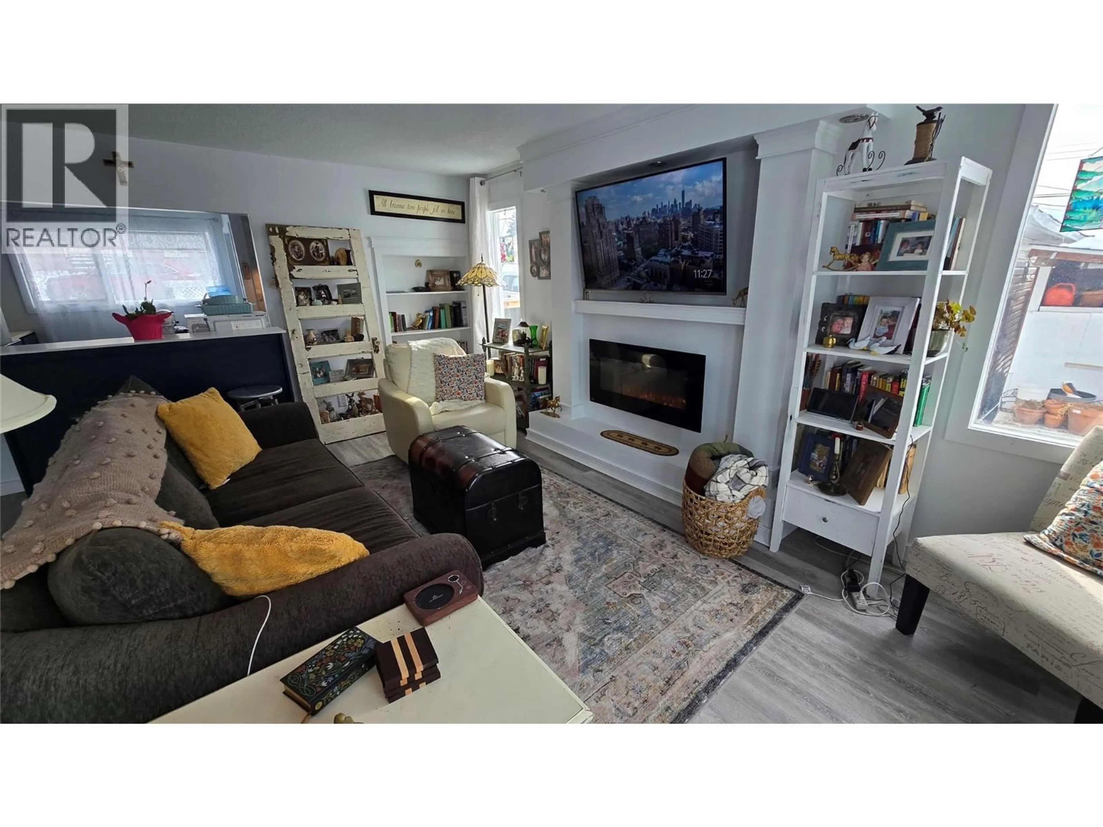 Living room with furniture, wood/laminate floor for 601 97A AVENUE, Dawson Creek British Columbia V1G1R2