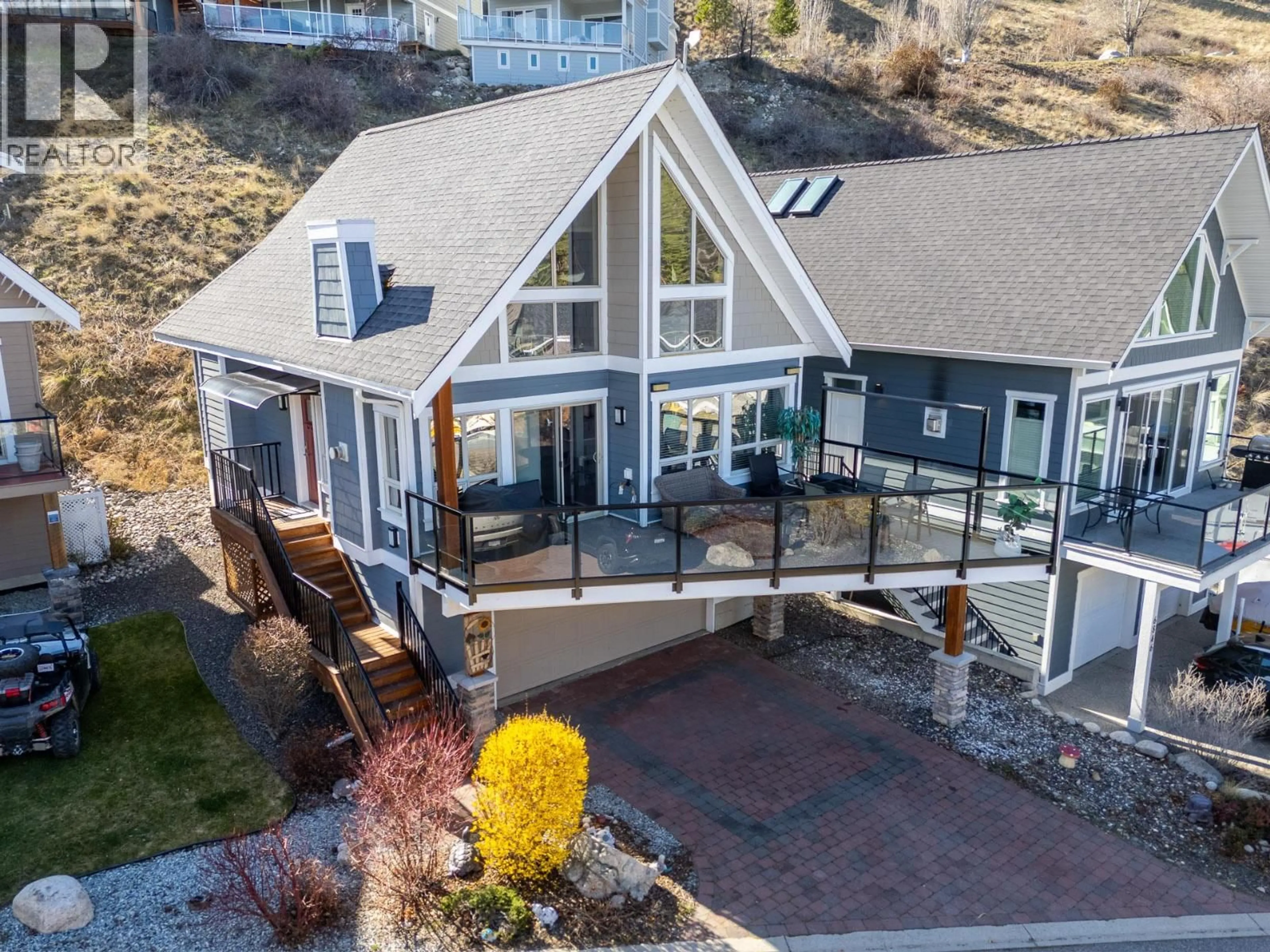 A pic from outside/outdoor area/front of a property/back of a property/a pic from drone, mountain view for 6844 SANTIAGO LOOP, Kelowna British Columbia V1Z3R8