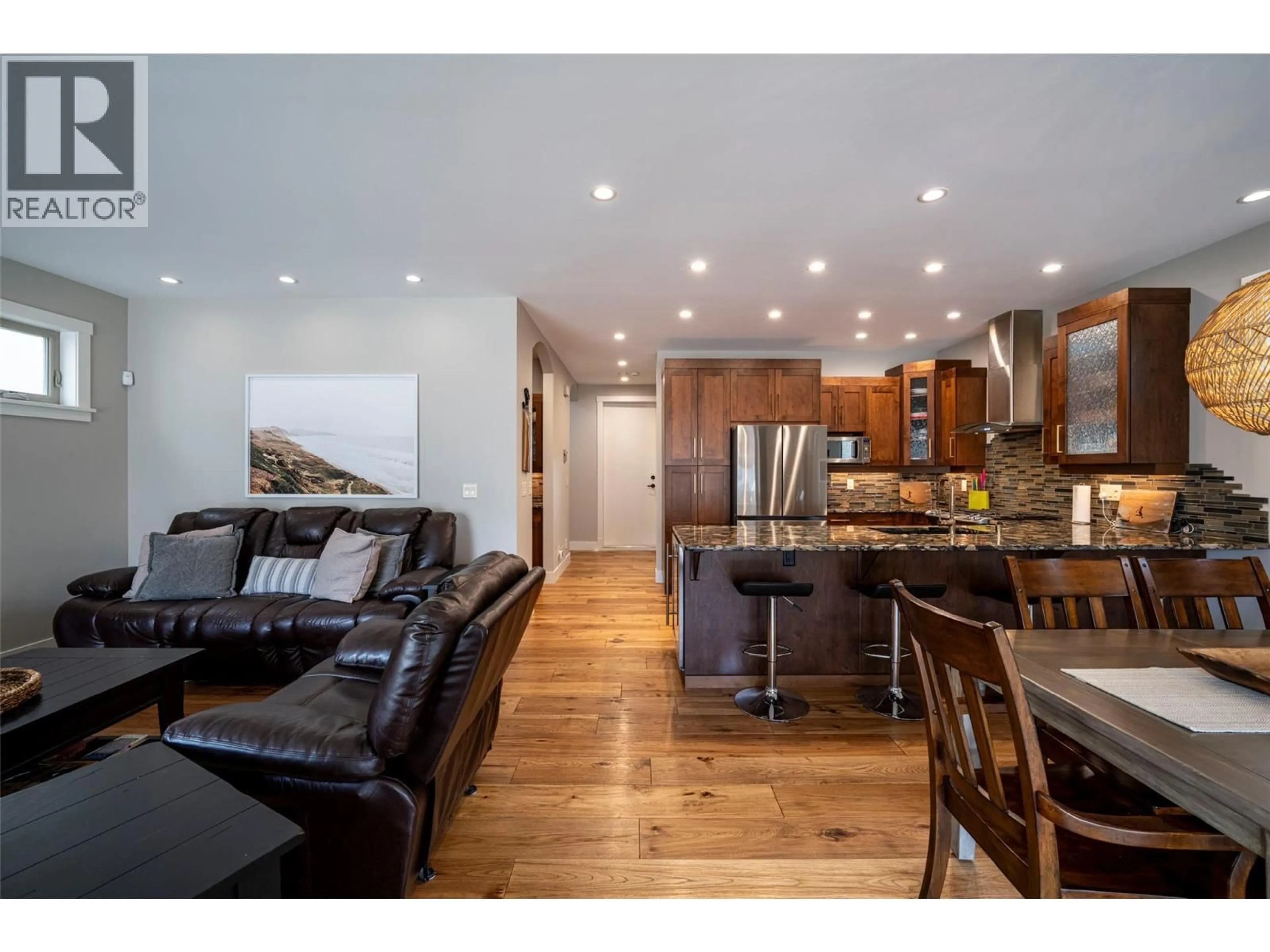 Open concept kitchen, wood/laminate floor for 4 - 7373 BROOKS LANE, Vernon British Columbia V1H1G6