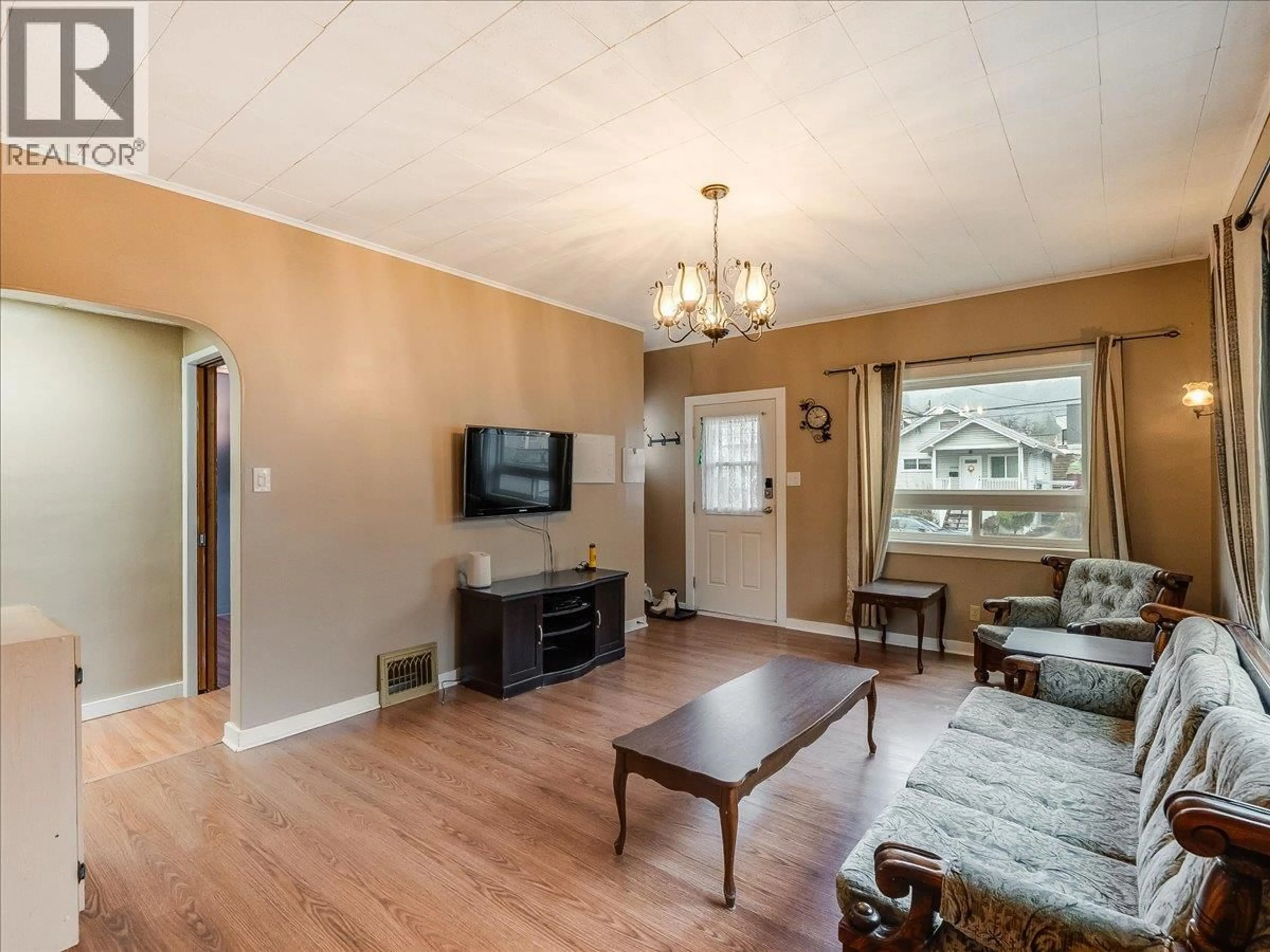 Living room with furniture, wood/laminate floor for 1550 COLUMBIA AVENUE, Trail British Columbia V1R1J9