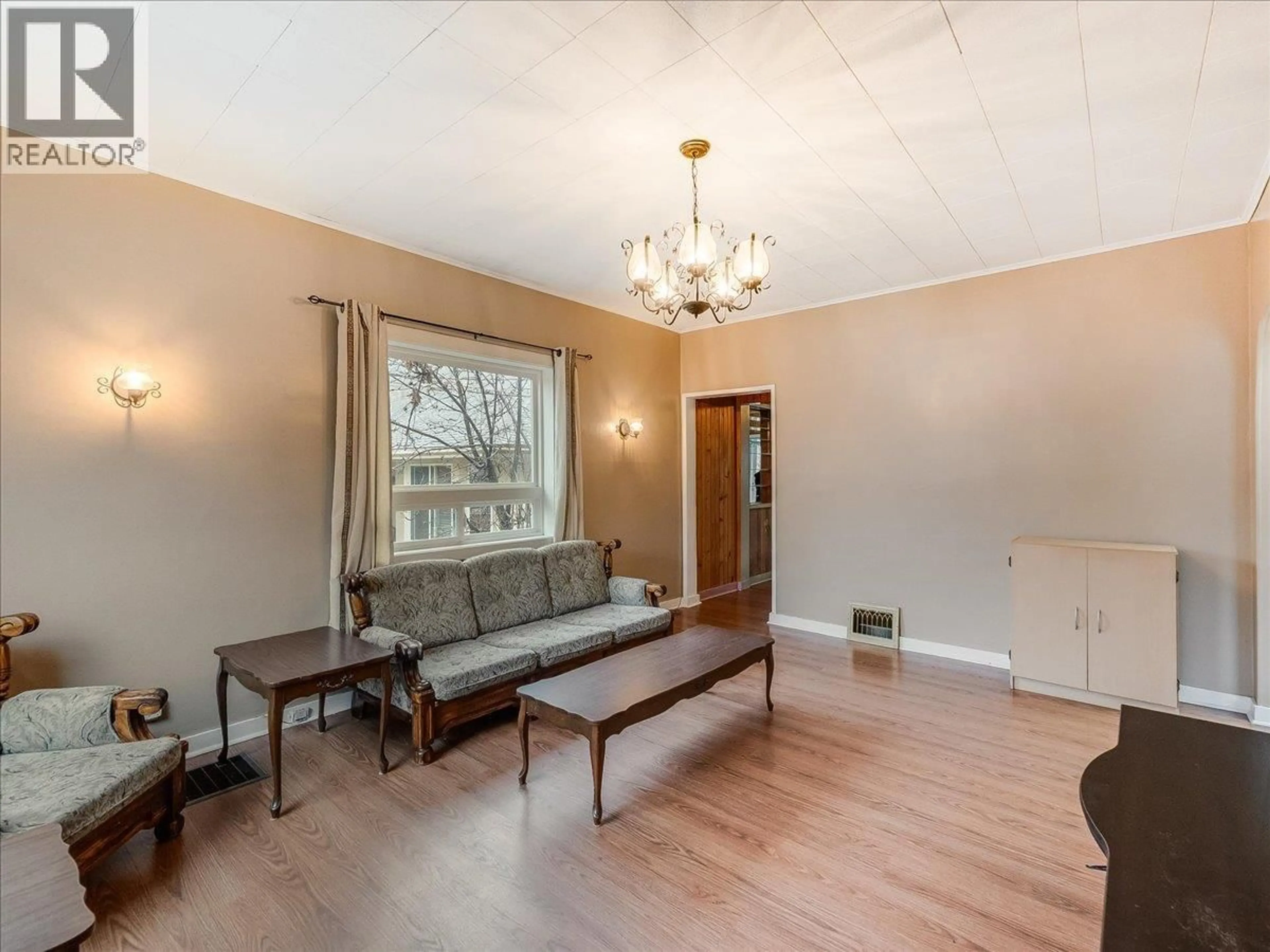 Living room with furniture, wood/laminate floor for 1550 COLUMBIA AVENUE, Trail British Columbia V1R1J9