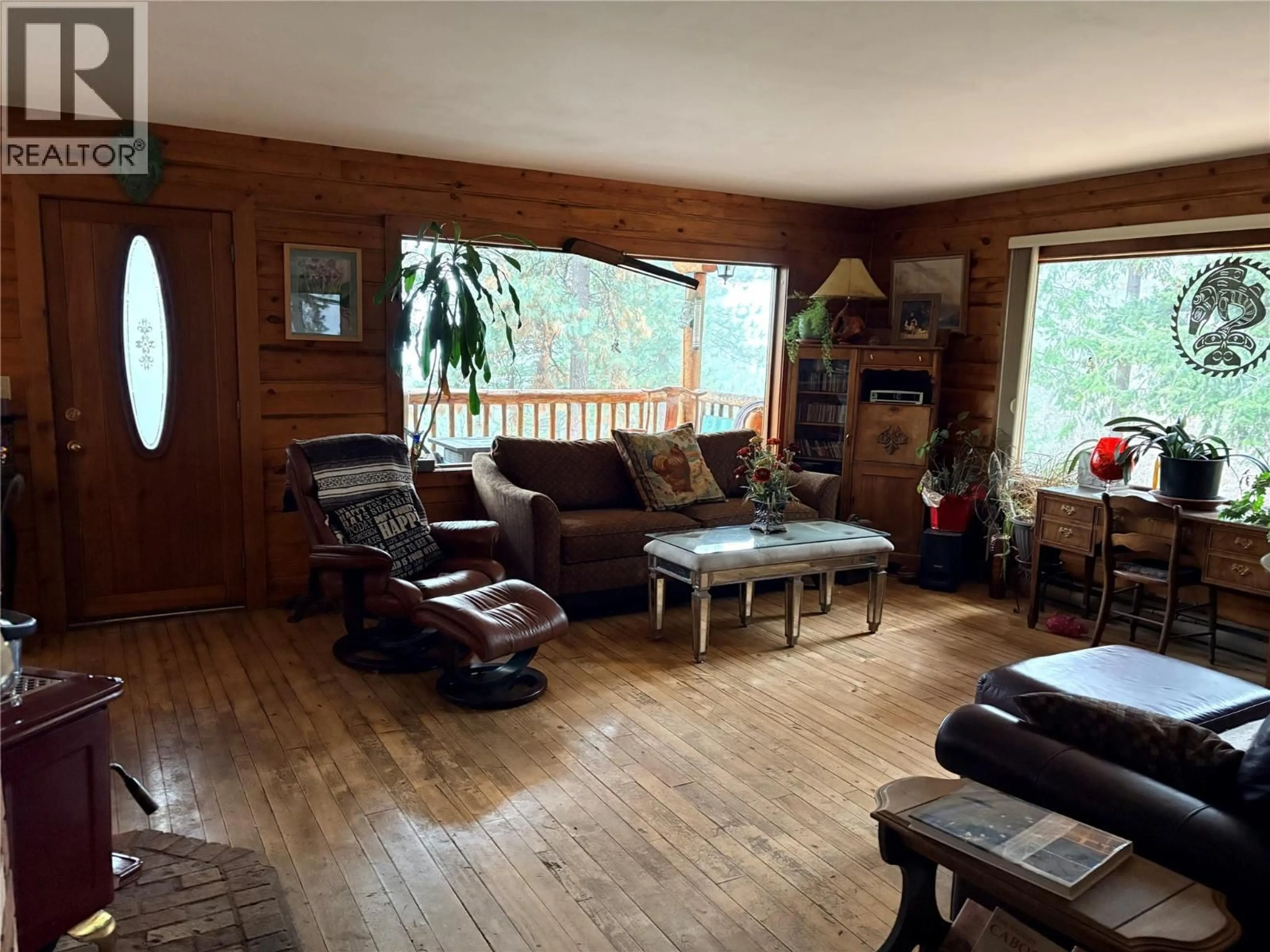 Living room with furniture, wood/laminate floor for 7072 GLENFIR ROAD, Naramata British Columbia V0H1N1