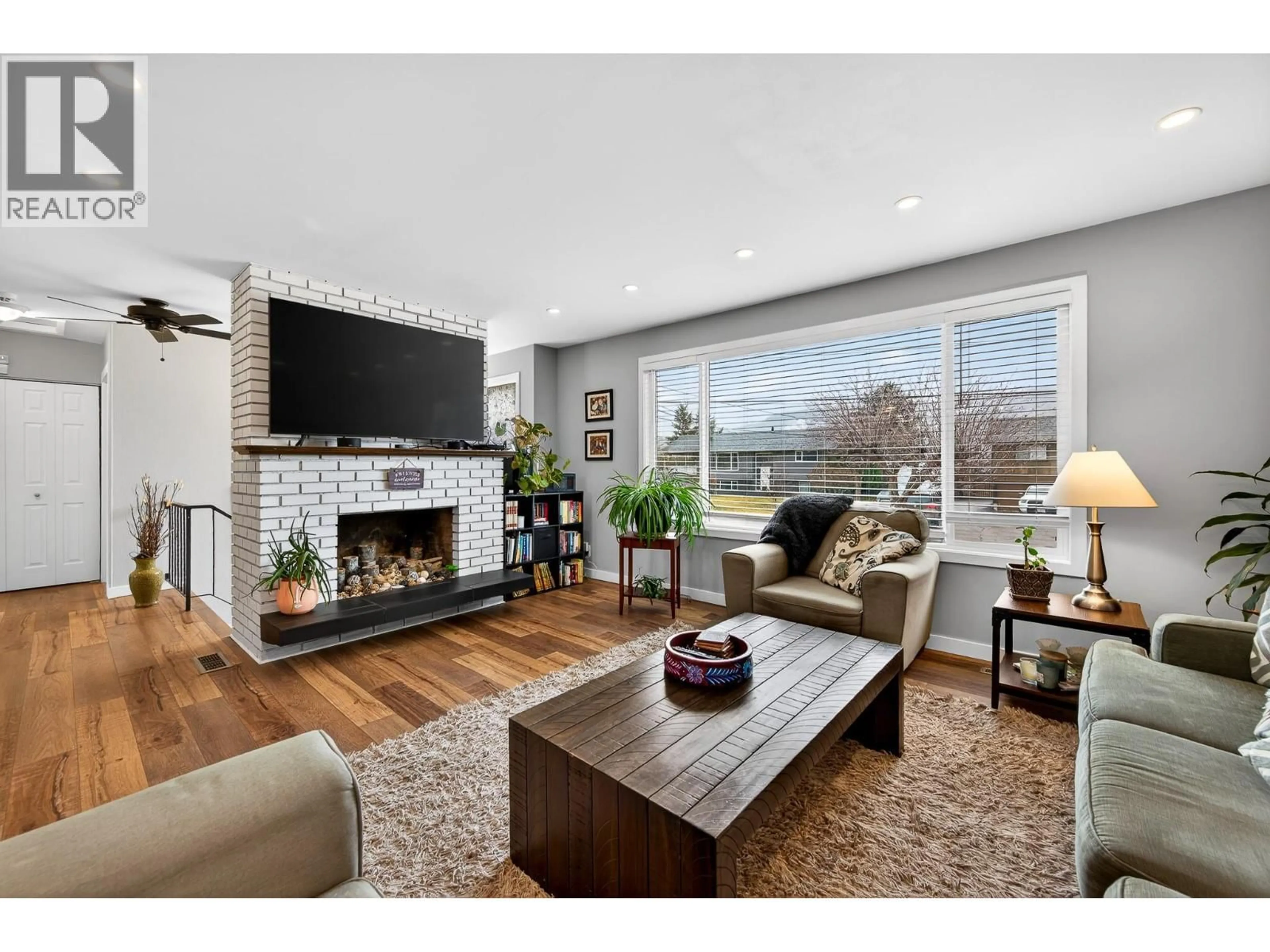 Living room with furniture, wood/laminate floor for 2436 GREENFIELD AVENUE, Kamloops British Columbia V2B4P7