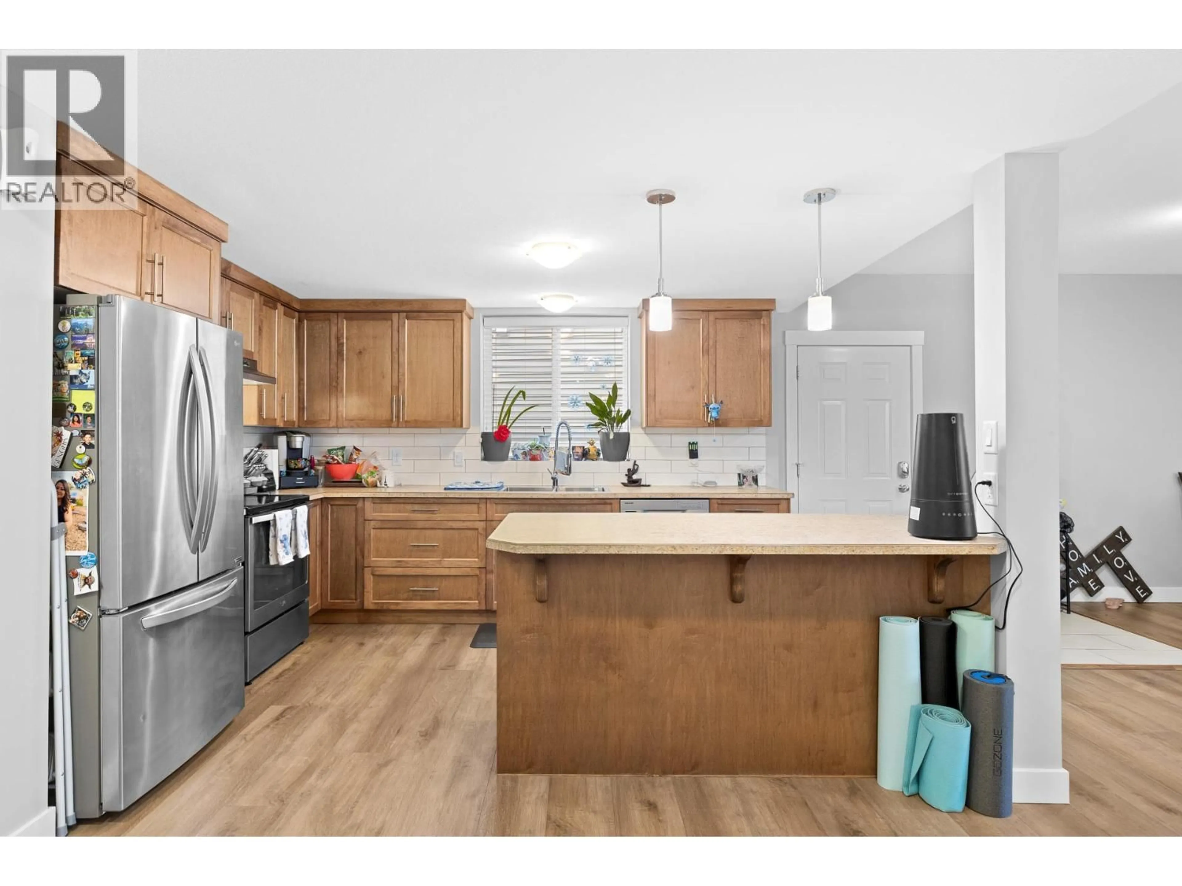 Open concept kitchen, wood/laminate floor for 4007 OKANAGAN AVENUE, Vernon British Columbia V1T1K8