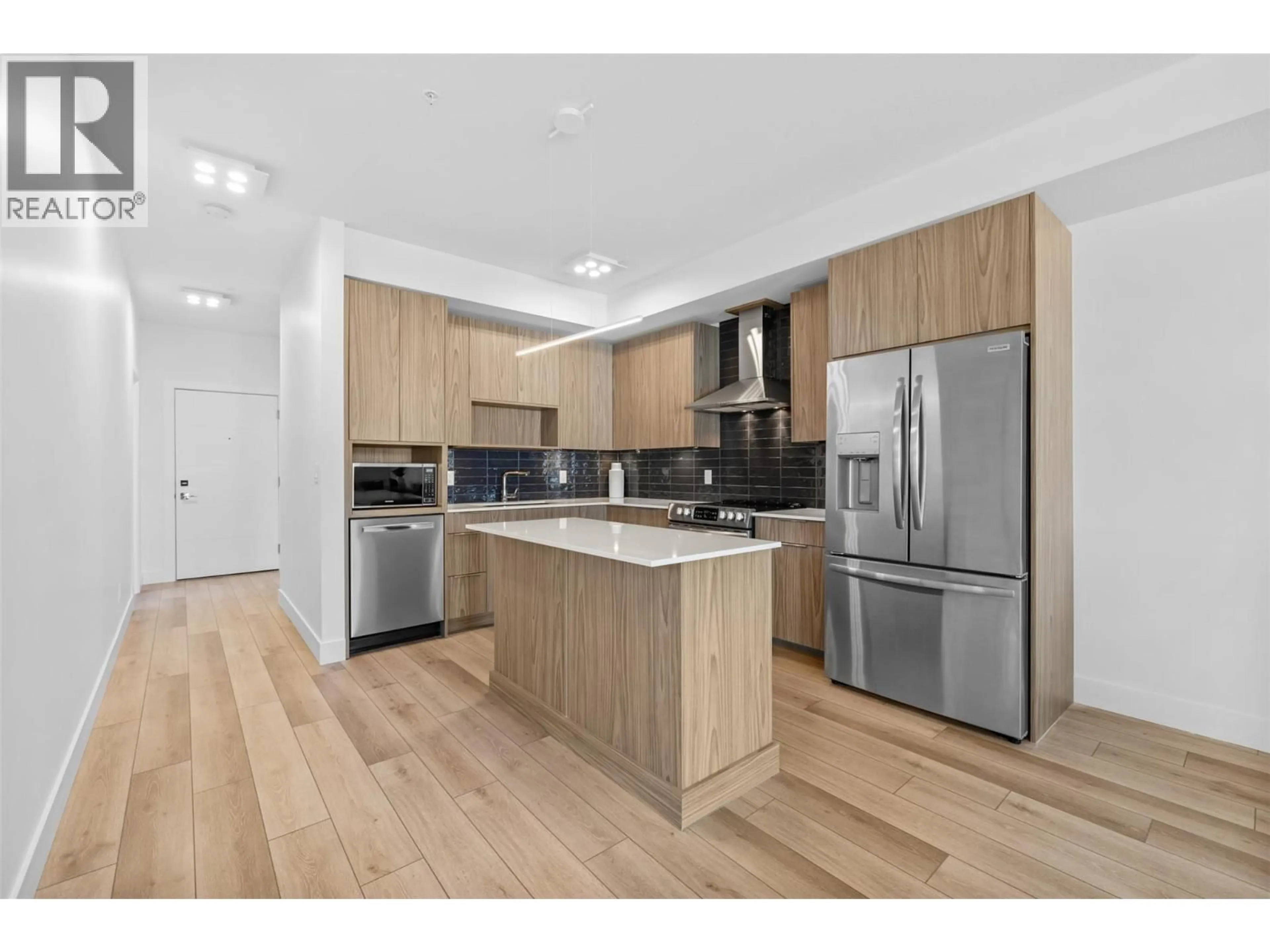 Open concept kitchen, wood/laminate floor for 401B - 3634 MISSION SPRINGS DRIVE, Kelowna British Columbia V1W0B2