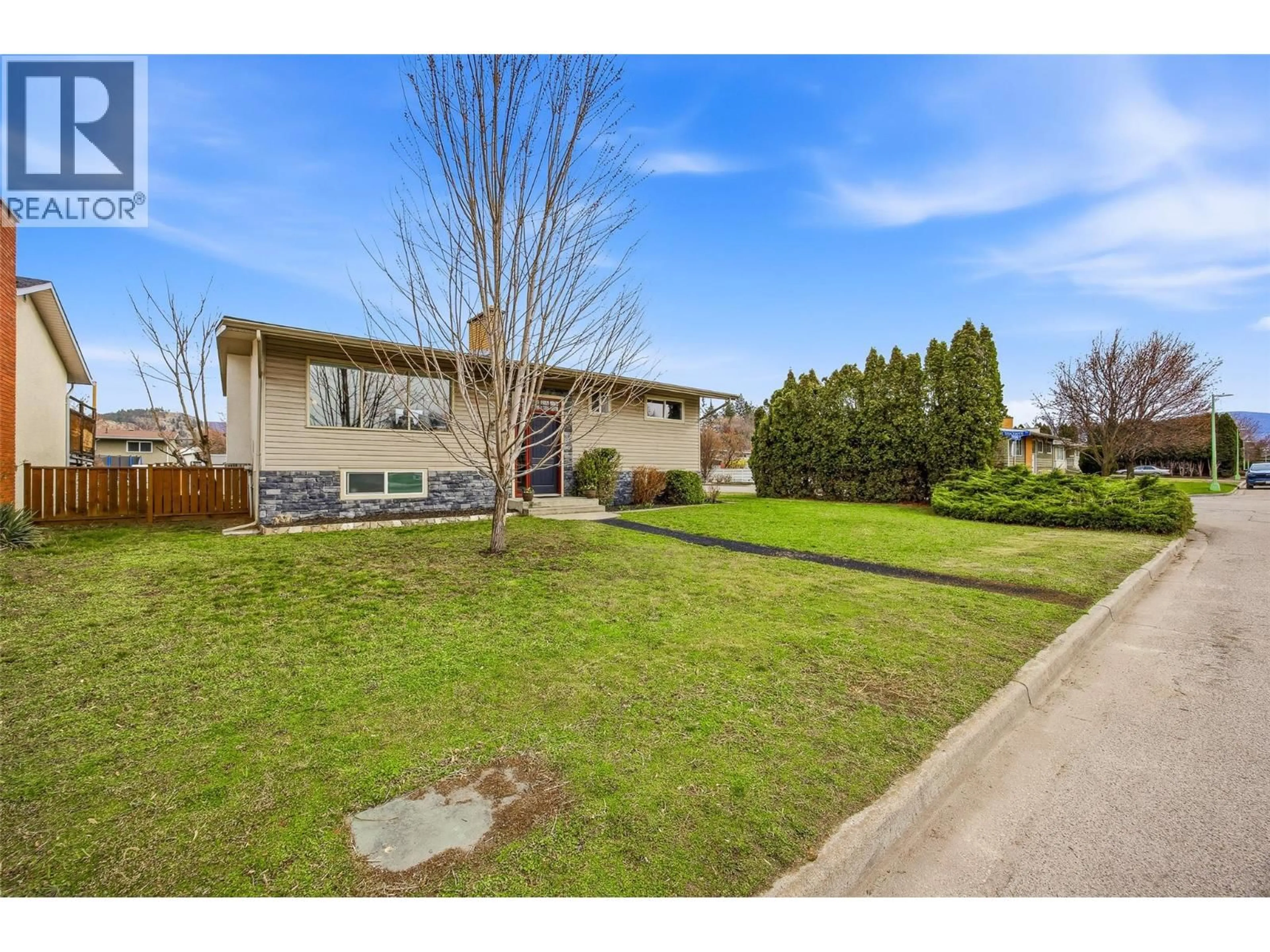 A pic from outside/outdoor area/front of a property/back of a property/a pic from drone, street for 1394 LOMBARDY SQUARE, Kelowna British Columbia V1Y3S4