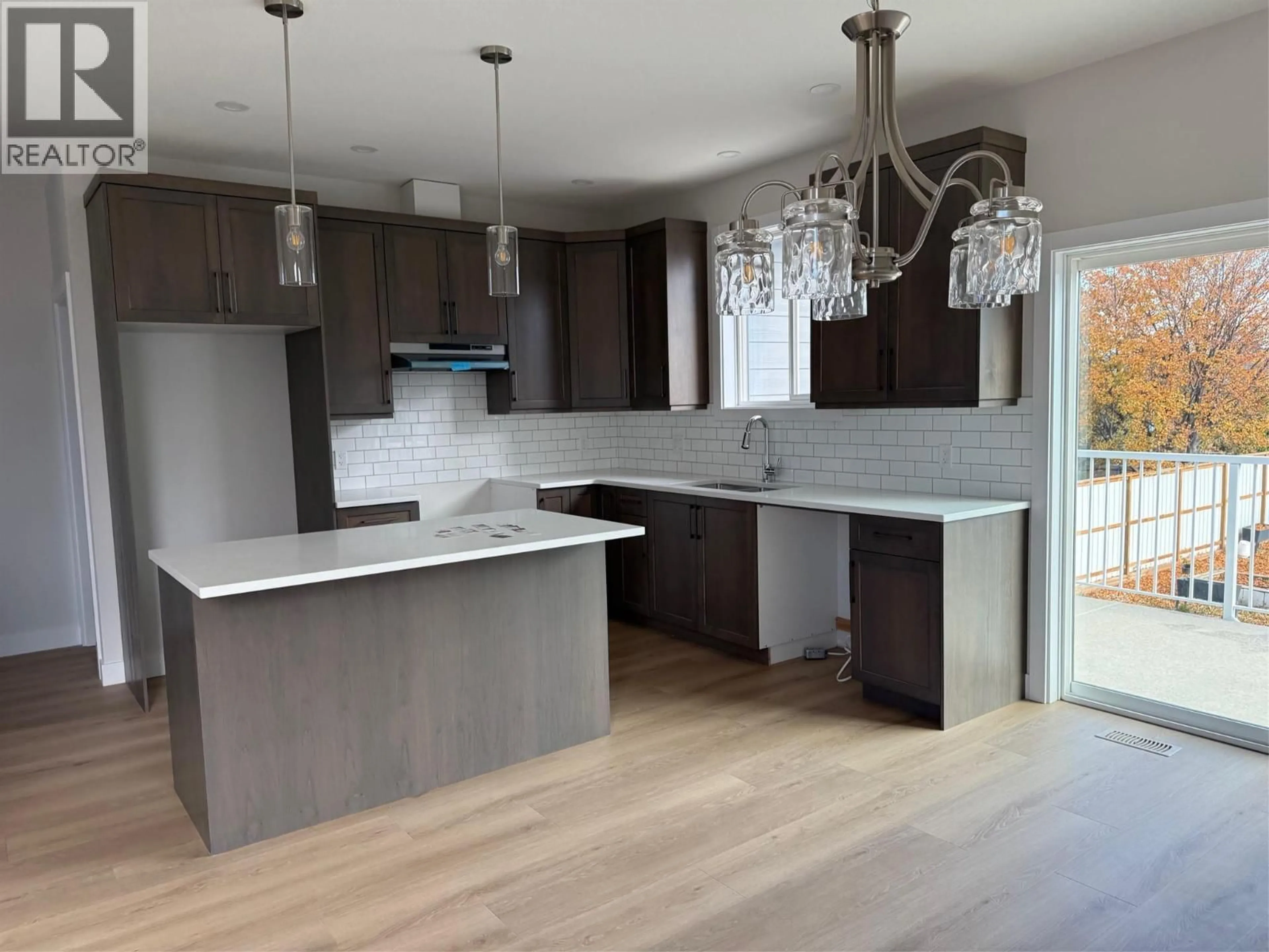Open concept kitchen, wood/laminate floor for 855 SCHREINER STREET, Kamloops British Columbia V2B5V5