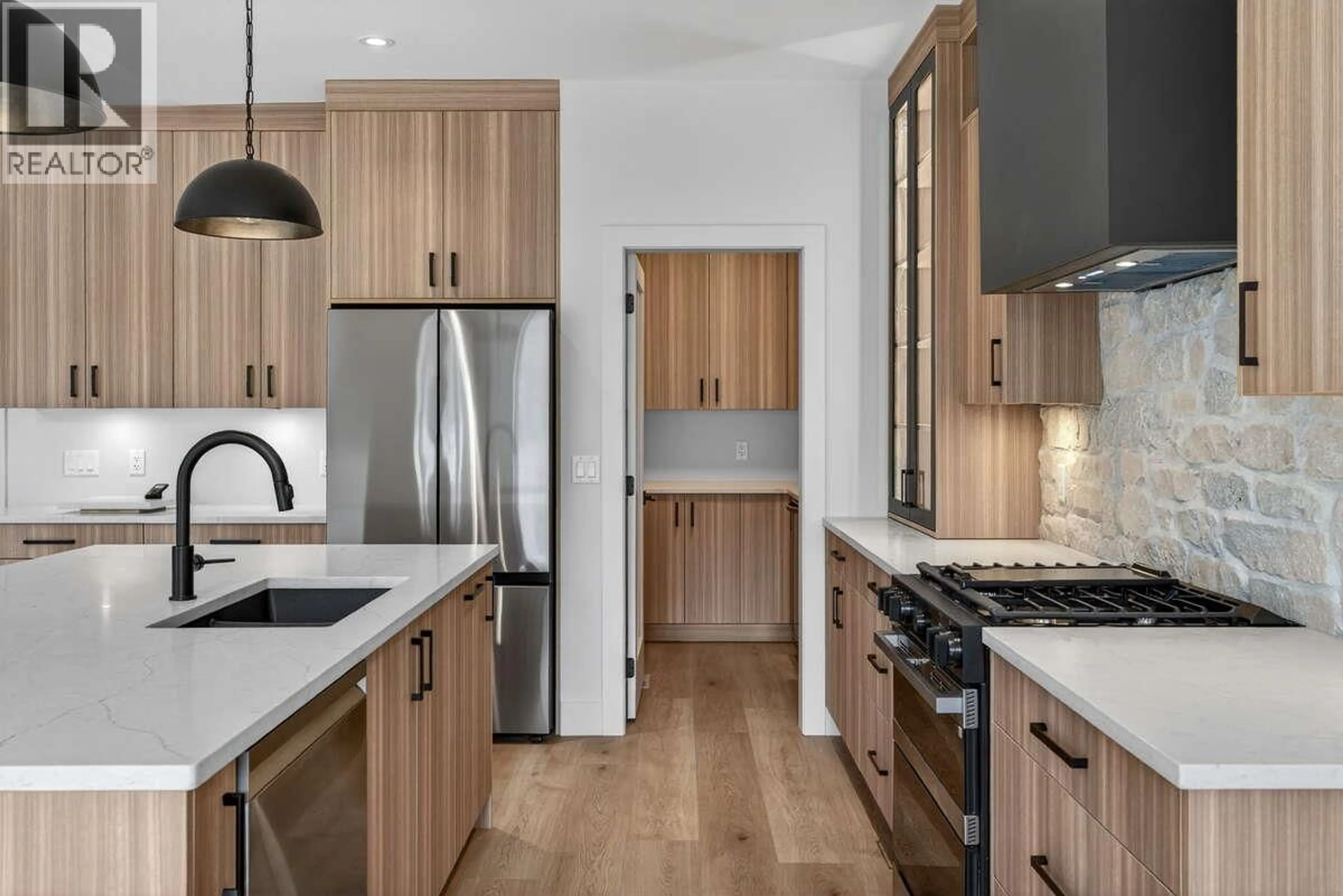 Open concept kitchen, wood/laminate floor for 2125 MONTENEGRO DRIVE, Kelowna British Columbia V1P0B2