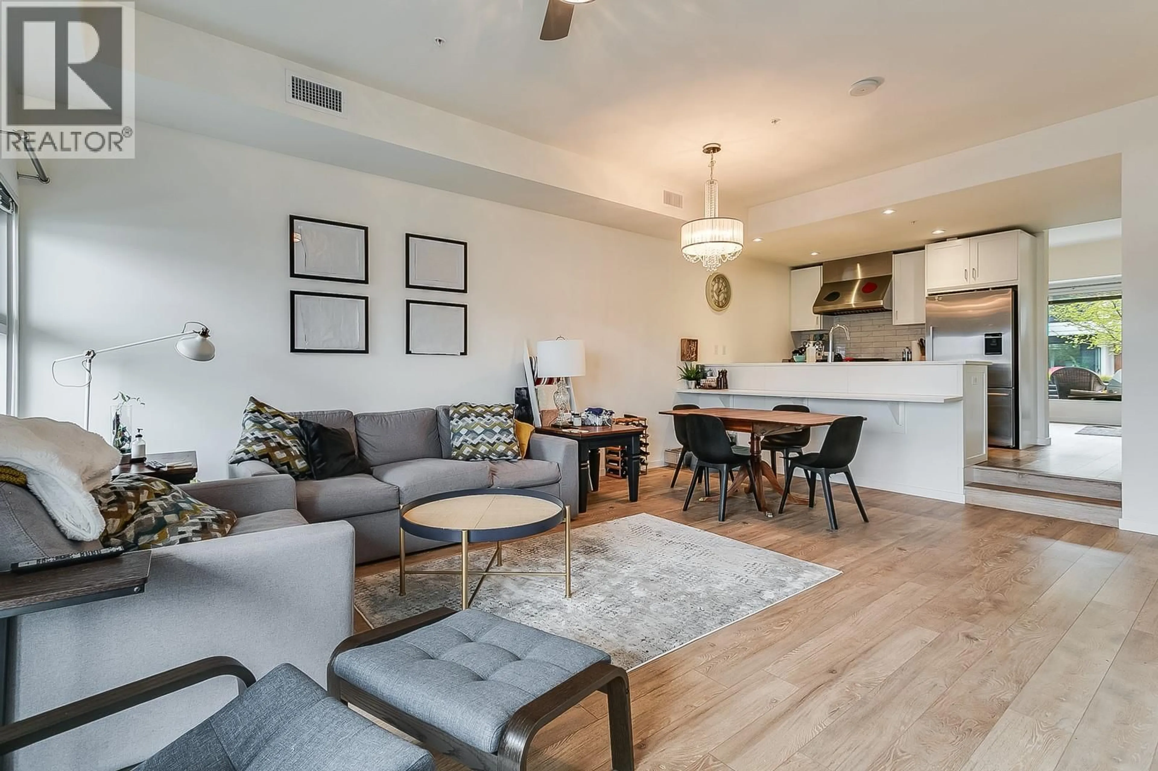 Living room with furniture, wood/laminate floor for 318 - 3030 PANDOSY STREET, Kelowna British Columbia V1Y0C4