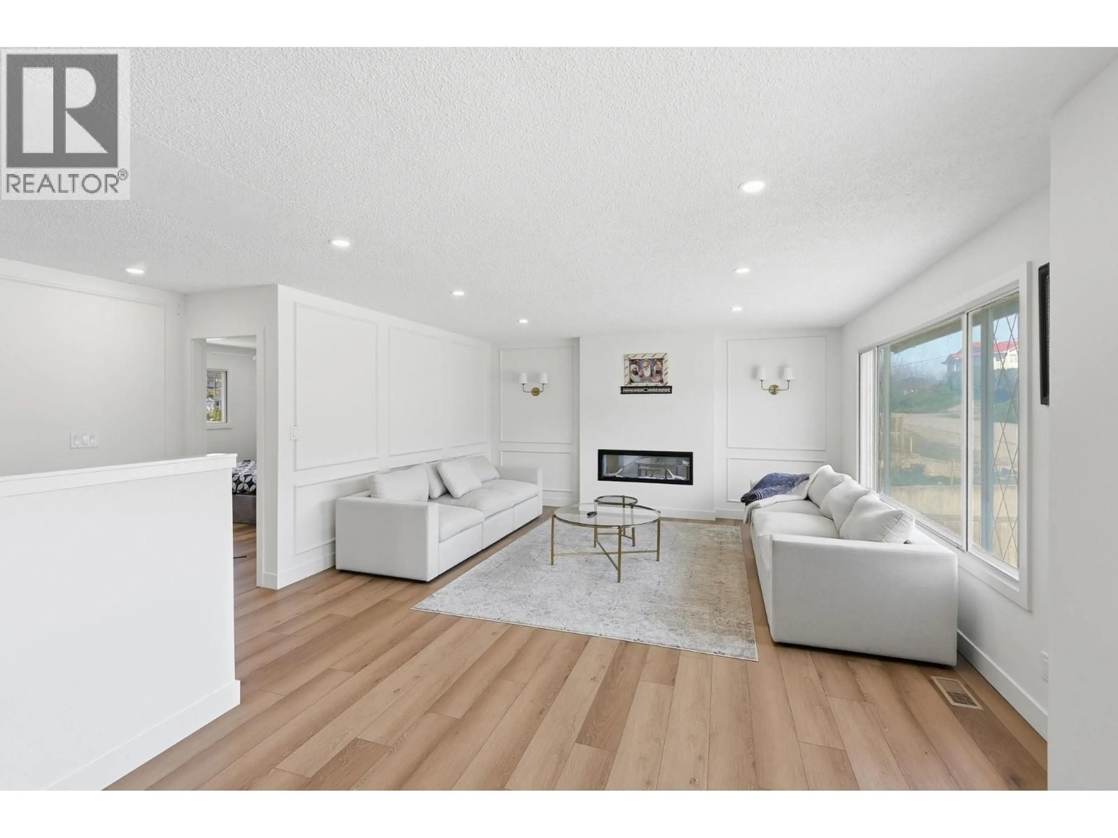 Living room with furniture, wood/laminate floor for 8913 JUBILEE DRIVE, Osoyoos British Columbia V0H1V2