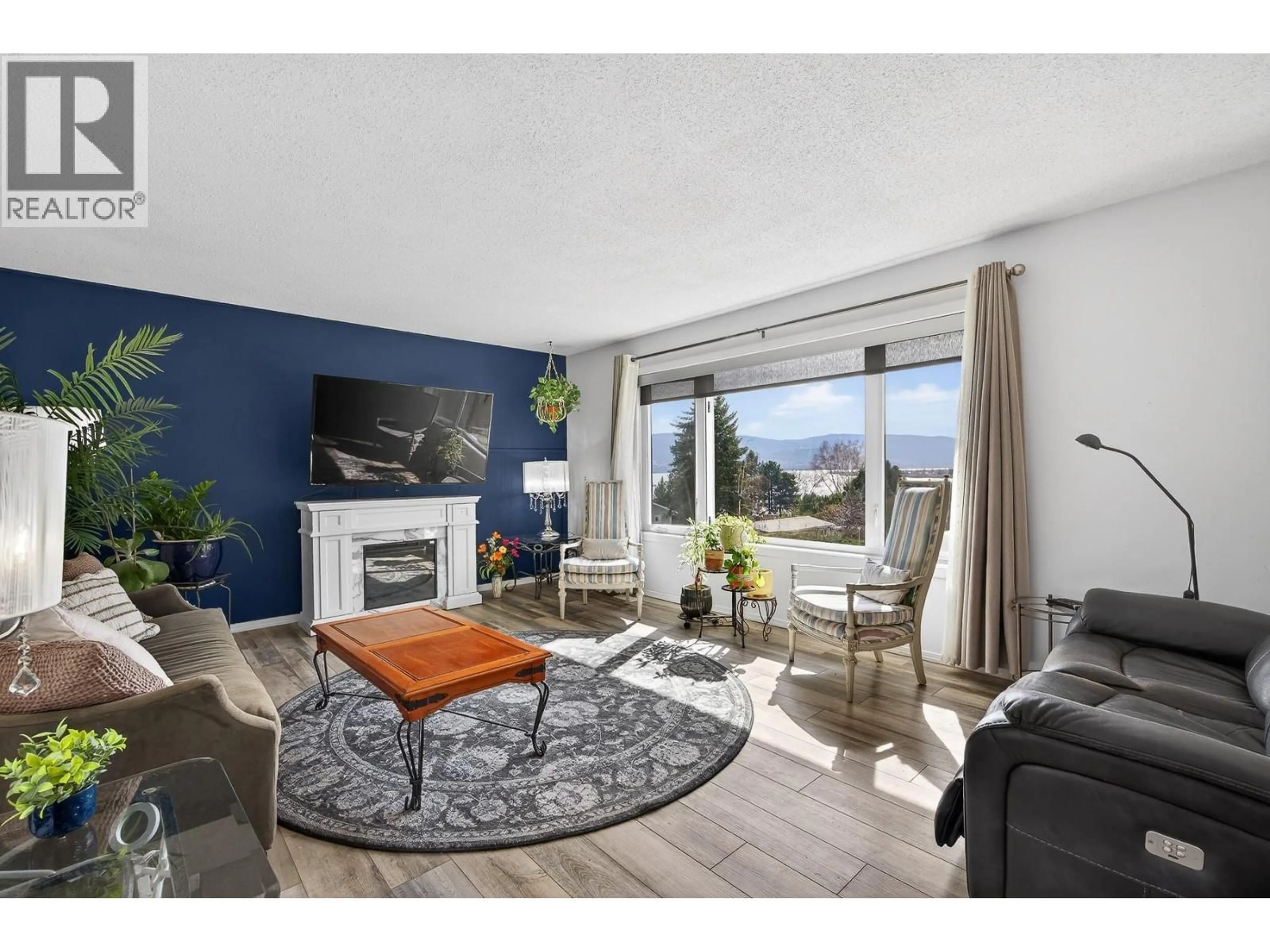 Living room with furniture, wood/laminate floor for 6100 MACDONALD STREET, Summerland British Columbia V0H1Z1