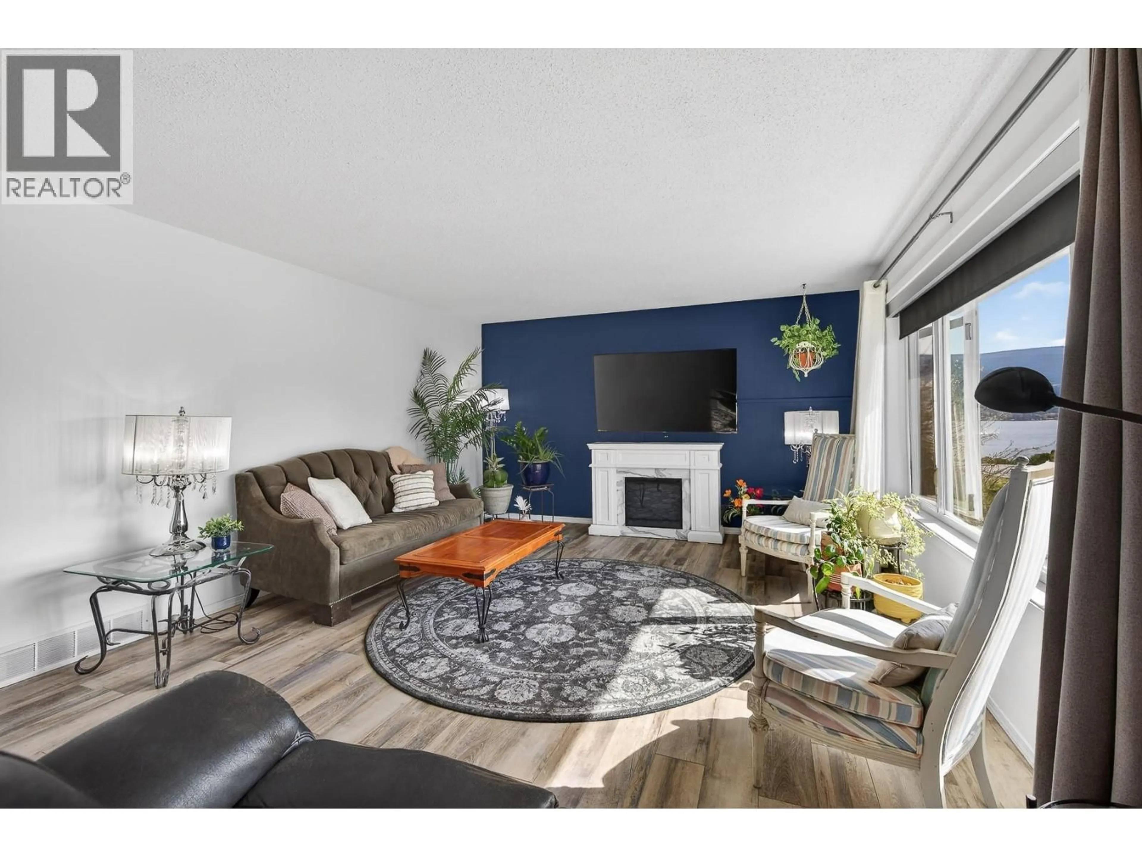 Living room with furniture, wood/laminate floor for 6100 MACDONALD STREET, Summerland British Columbia V0H1Z1