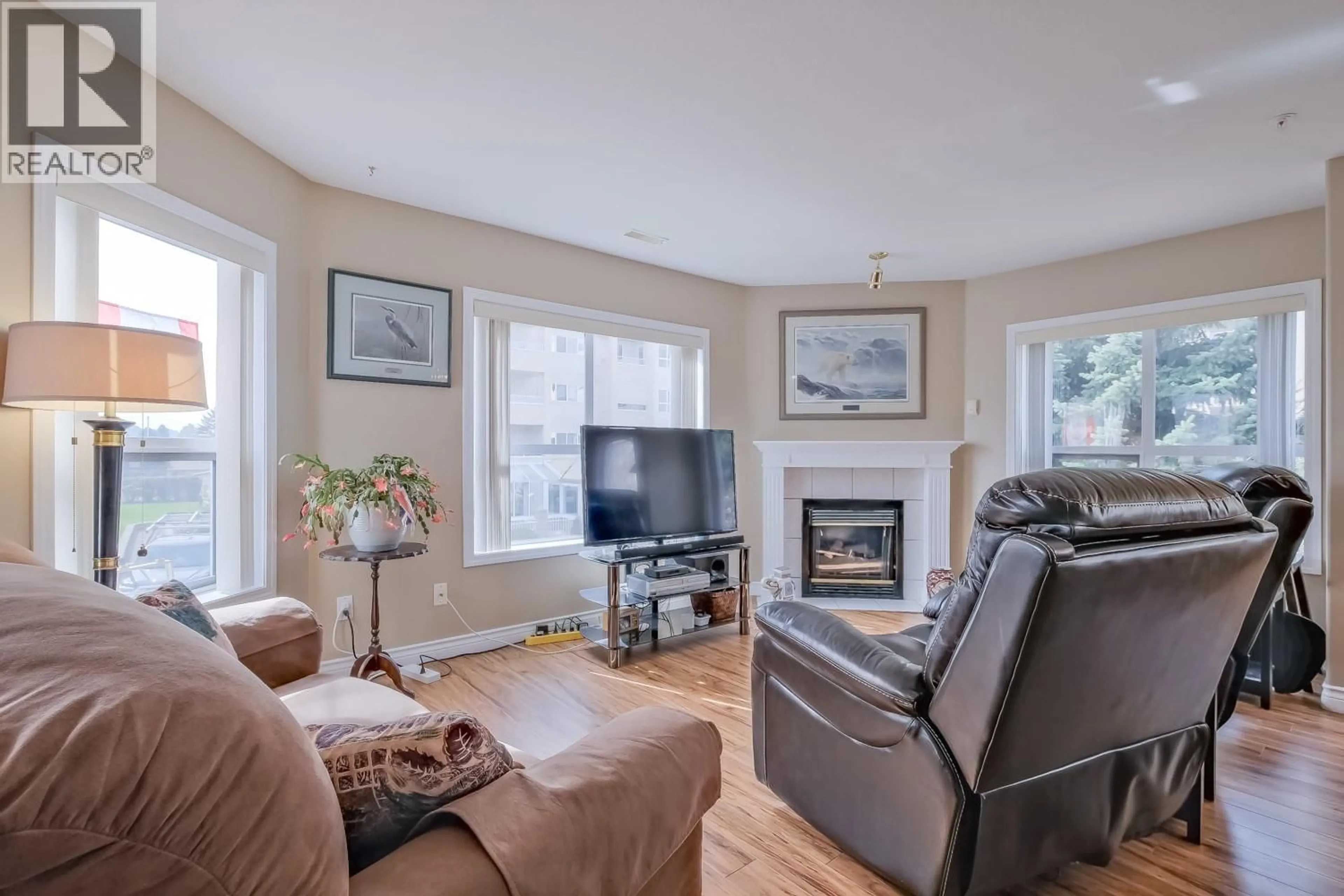 Living room with furniture, wood/laminate floor for 202 - 2245 ATKINSON STREET, Penticton British Columbia V2A8R7