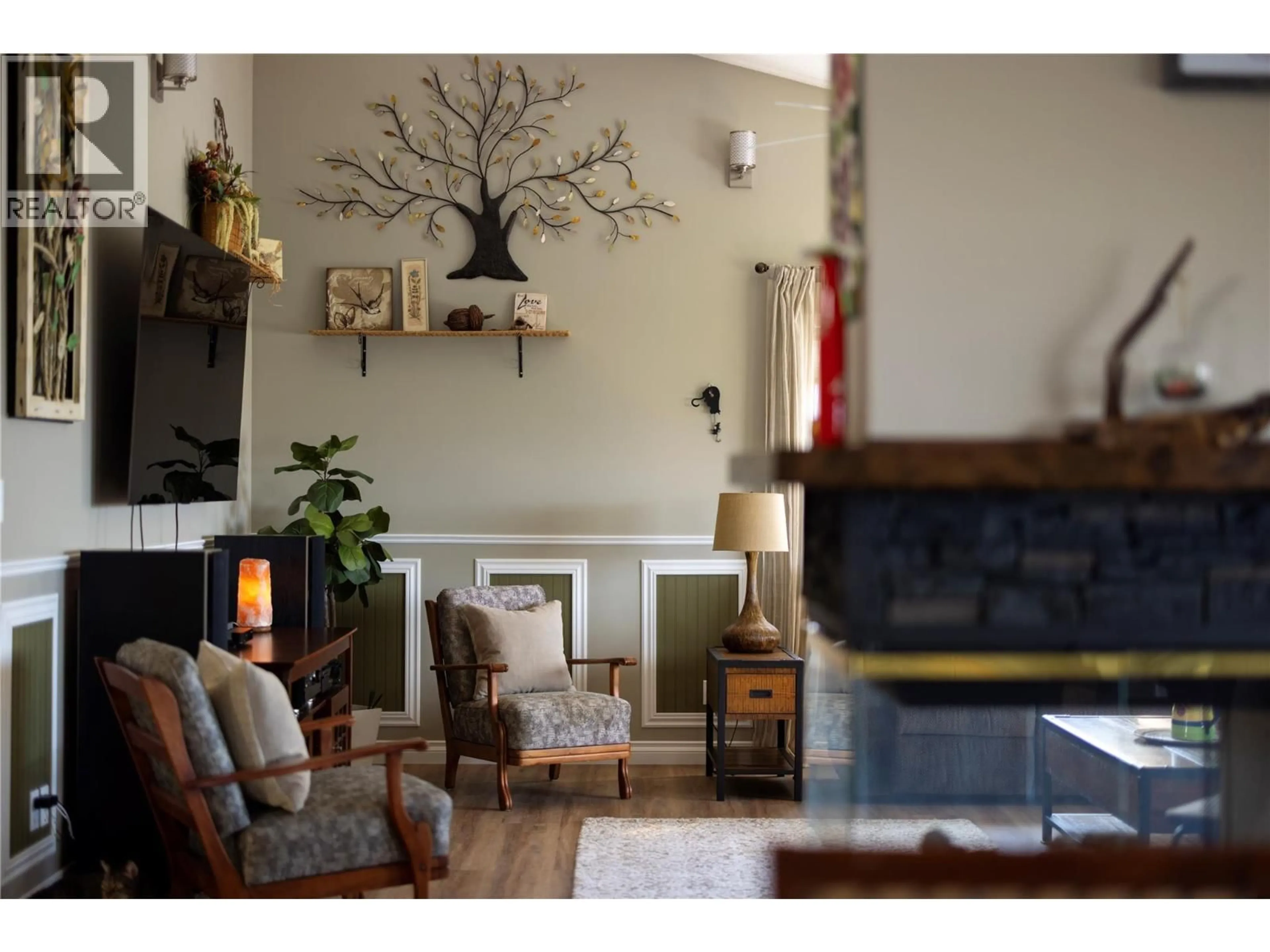 Living room with furniture, wood/laminate floor for 815 GALIANO ROAD, Vernon British Columbia V1B3B3