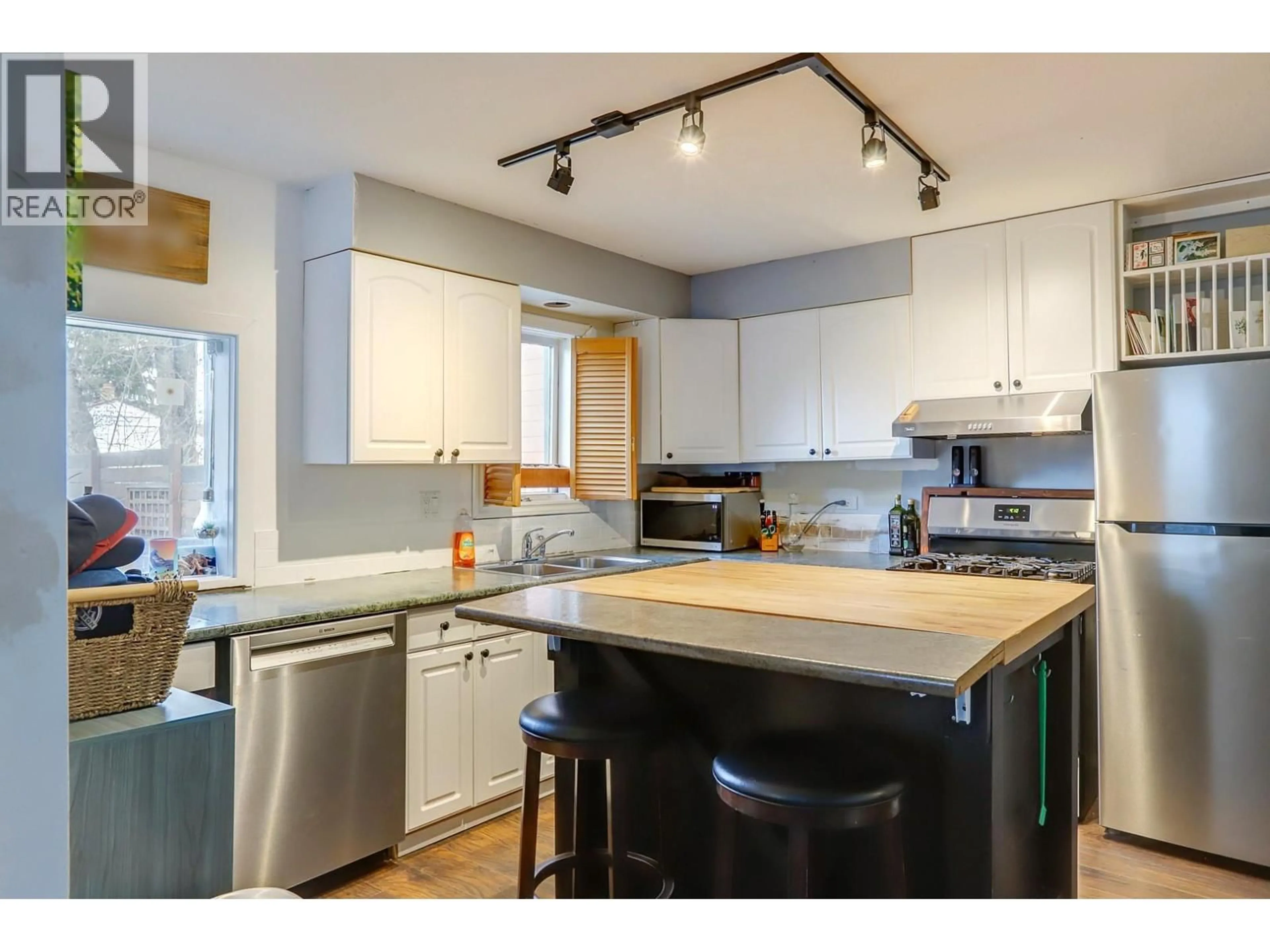 Open concept kitchen, wood/laminate floor for 1703 33 STREET, Vernon British Columbia V1T5P9