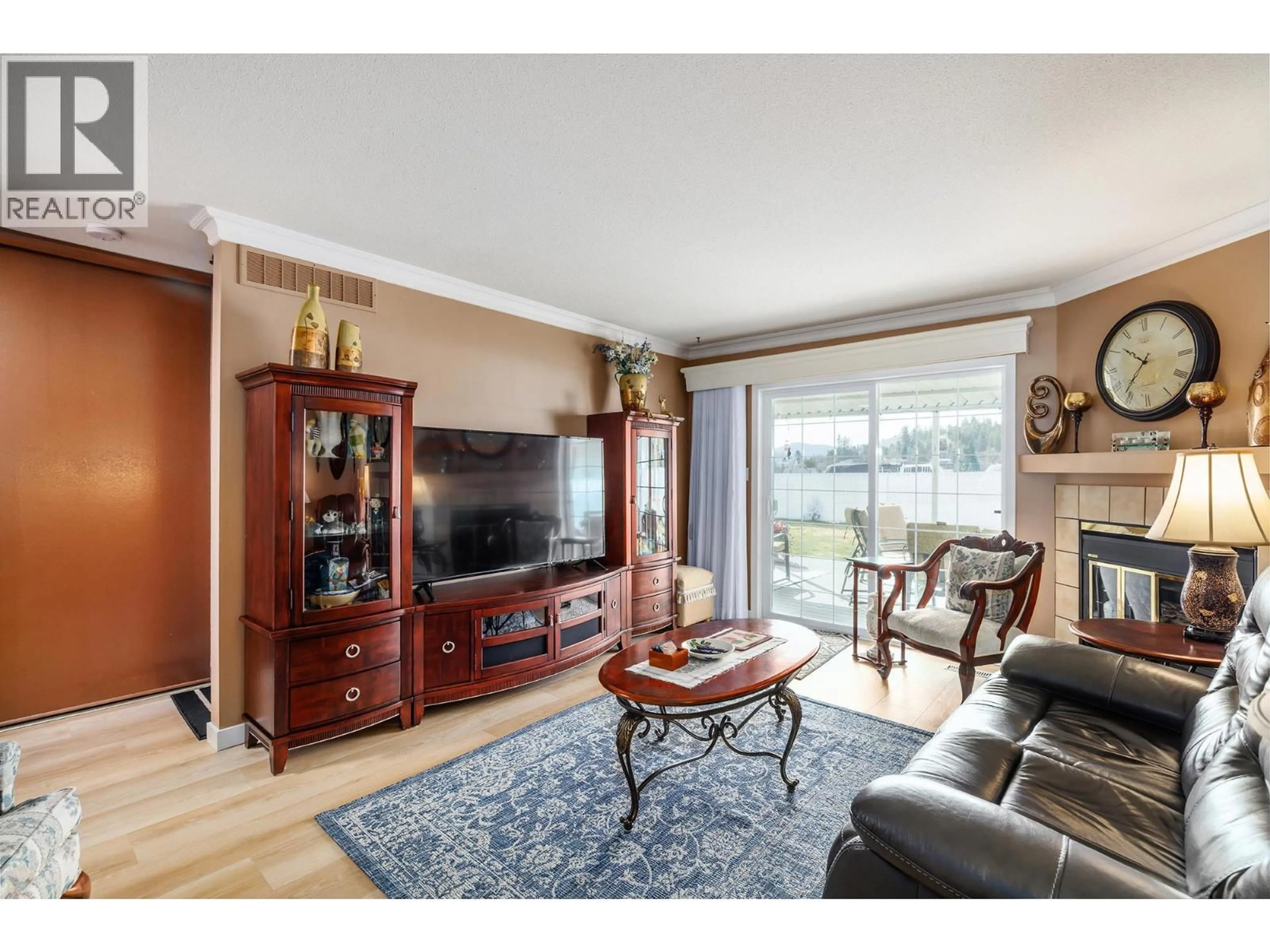 Living room with furniture, wood/laminate floor for 1 - 14616 GARNET AVENUE, Summerland British Columbia V0H1Z3