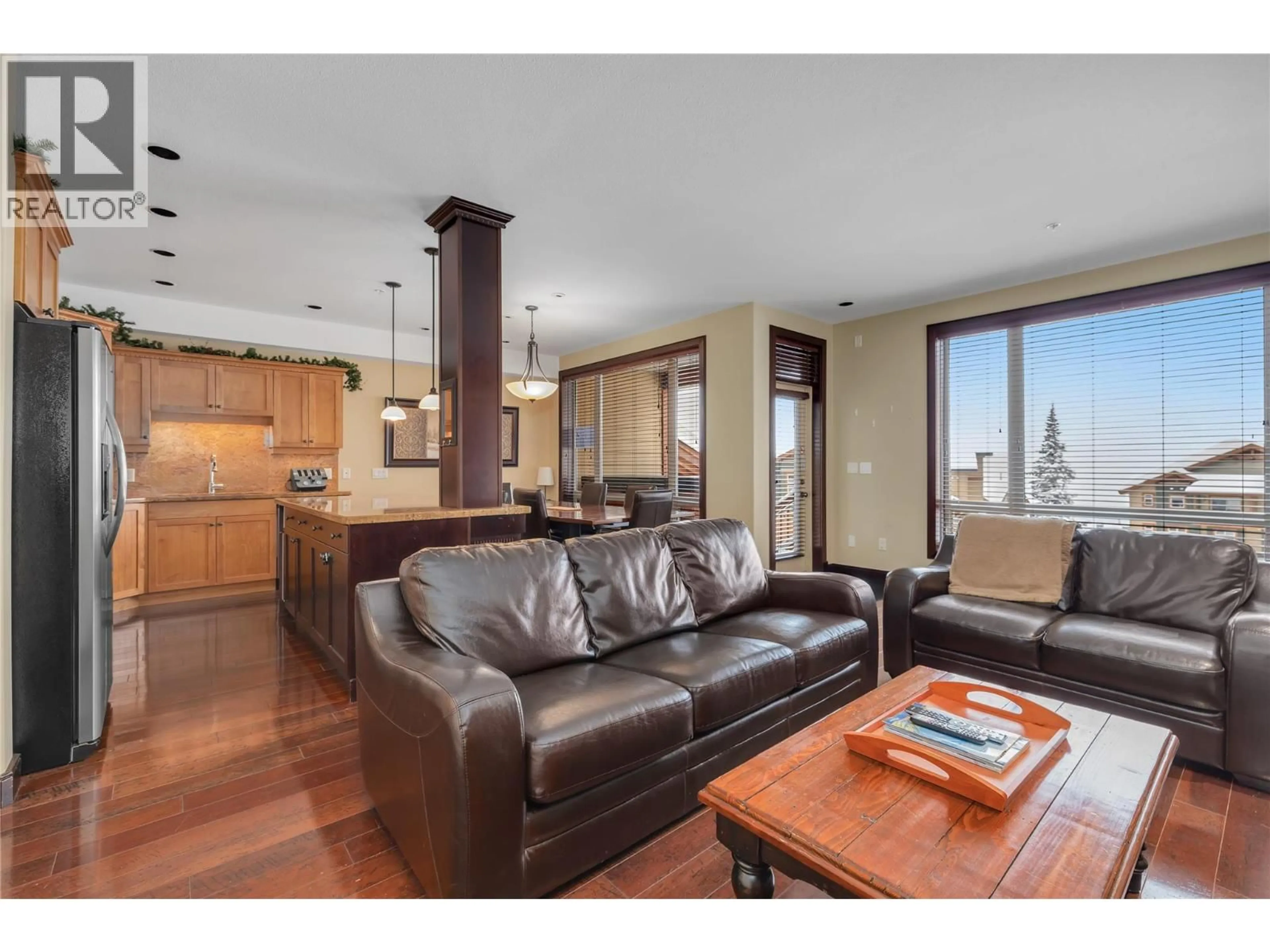 Living room with furniture, wood/laminate floor for 209 - 7700 PORCUPINE ROAD, Big White British Columbia V1P1P3