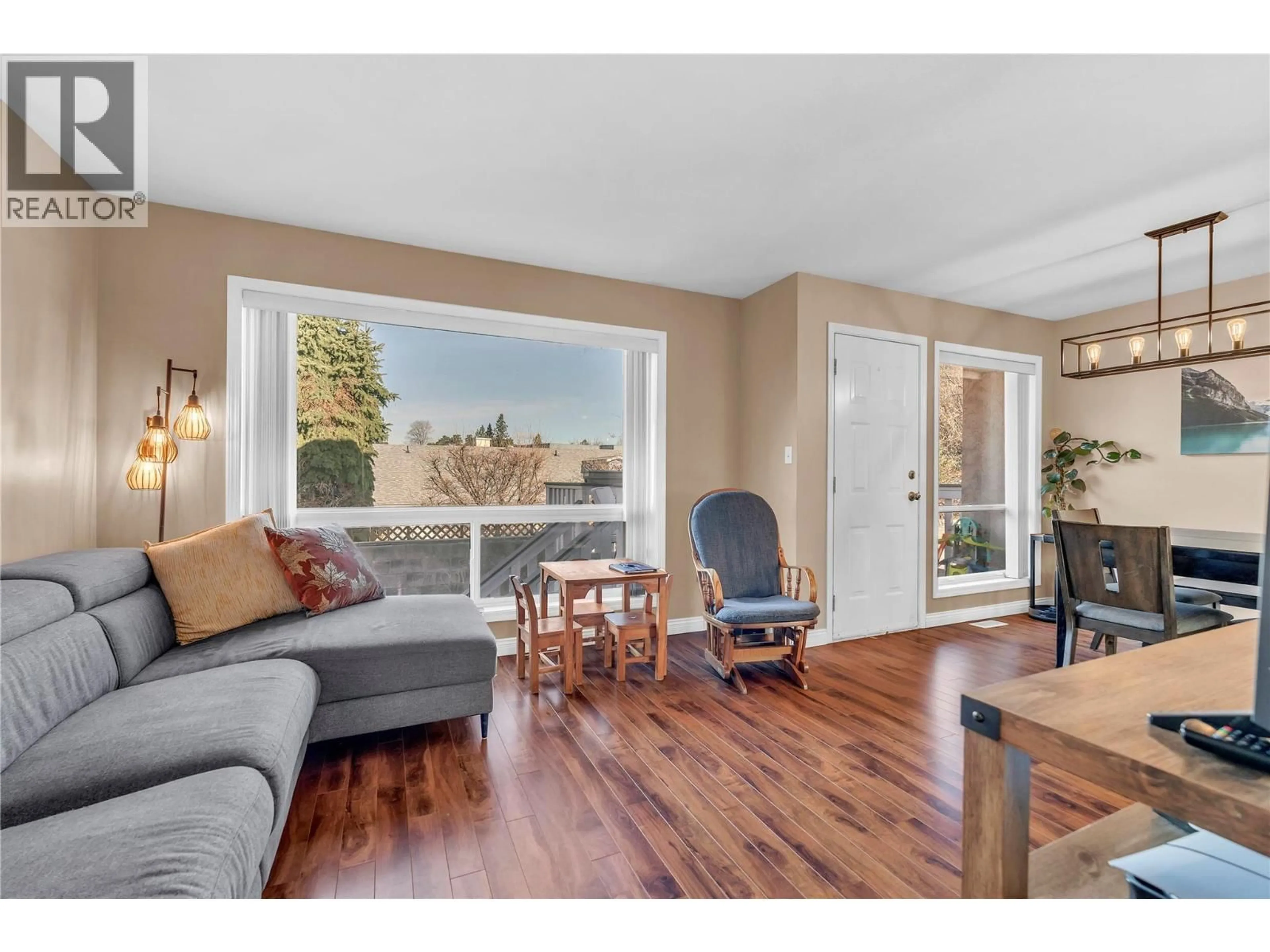 Living room with furniture, wood/laminate floor for 179 - 1458 PENTICTON AVENUE, Penticton British Columbia V2A8L3