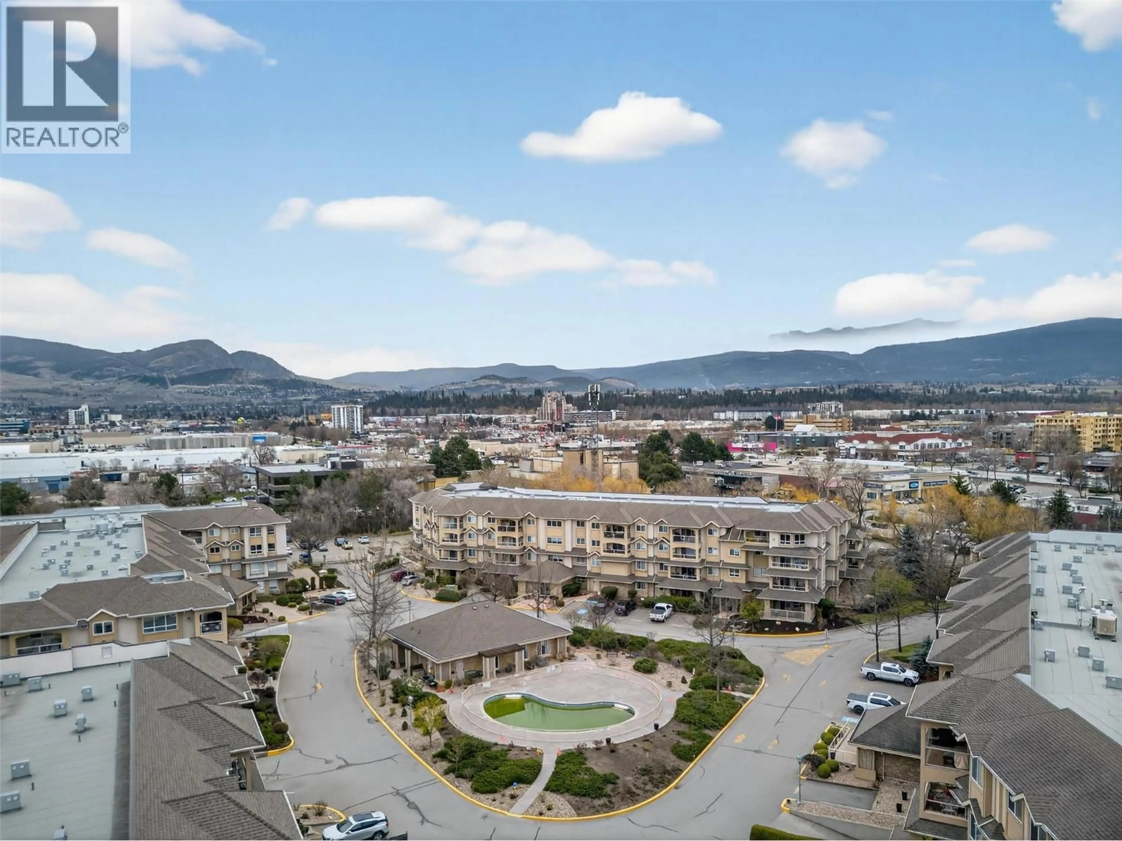 A pic from outside/outdoor area/front of a property/back of a property/a pic from drone, mountain view for 213 - 1966 ENTERPRISE WAY, Kelowna British Columbia V1Y9S8