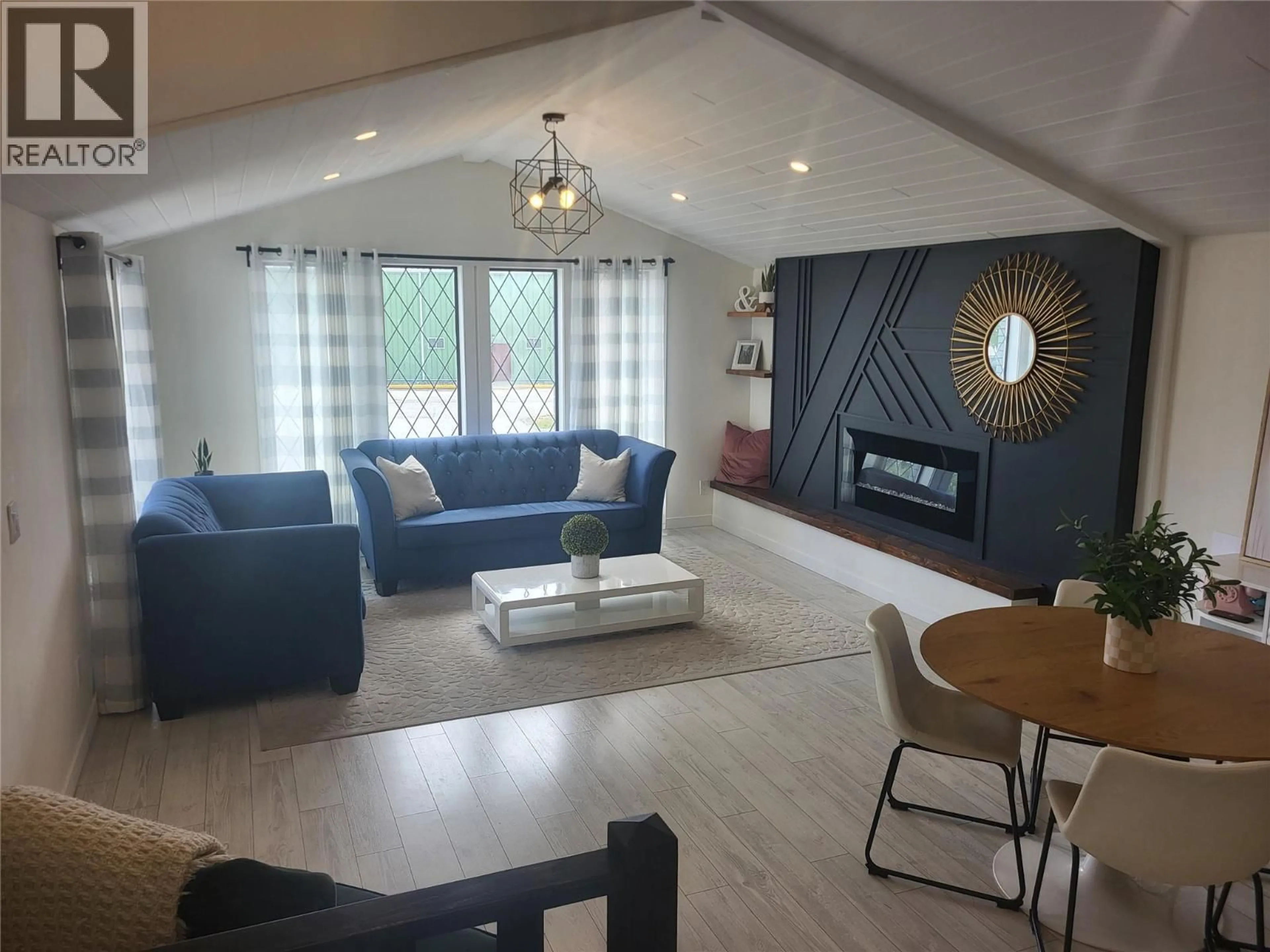 Living room with furniture, wood/laminate floor for 9504 HUMMINGBIRD LANE, Osoyoos British Columbia V0H1V5