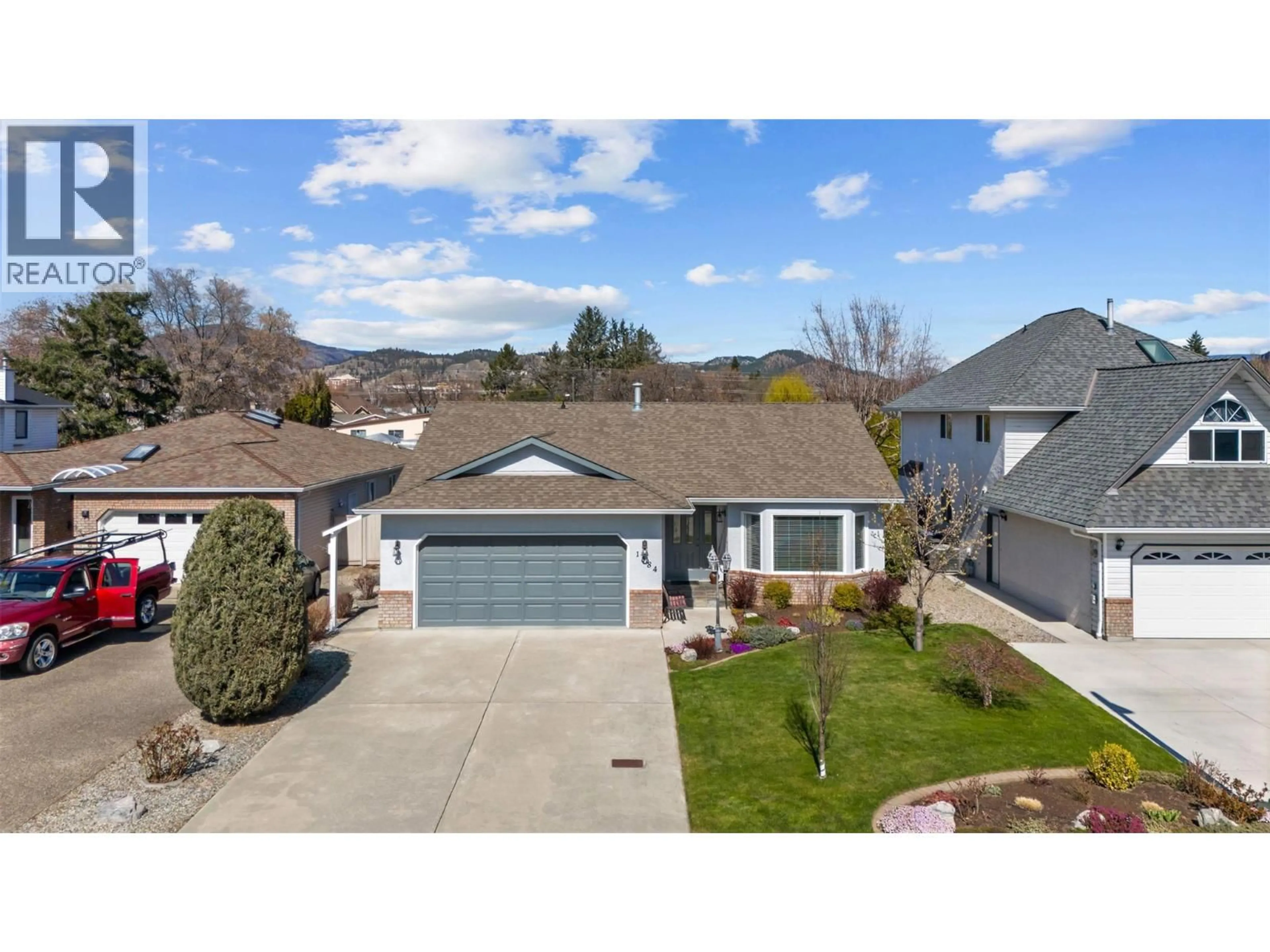 A pic from outside/outdoor area/front of a property/back of a property/a pic from drone, street for 1384 NELSON PLACE, Kelowna British Columbia V1Y9H4