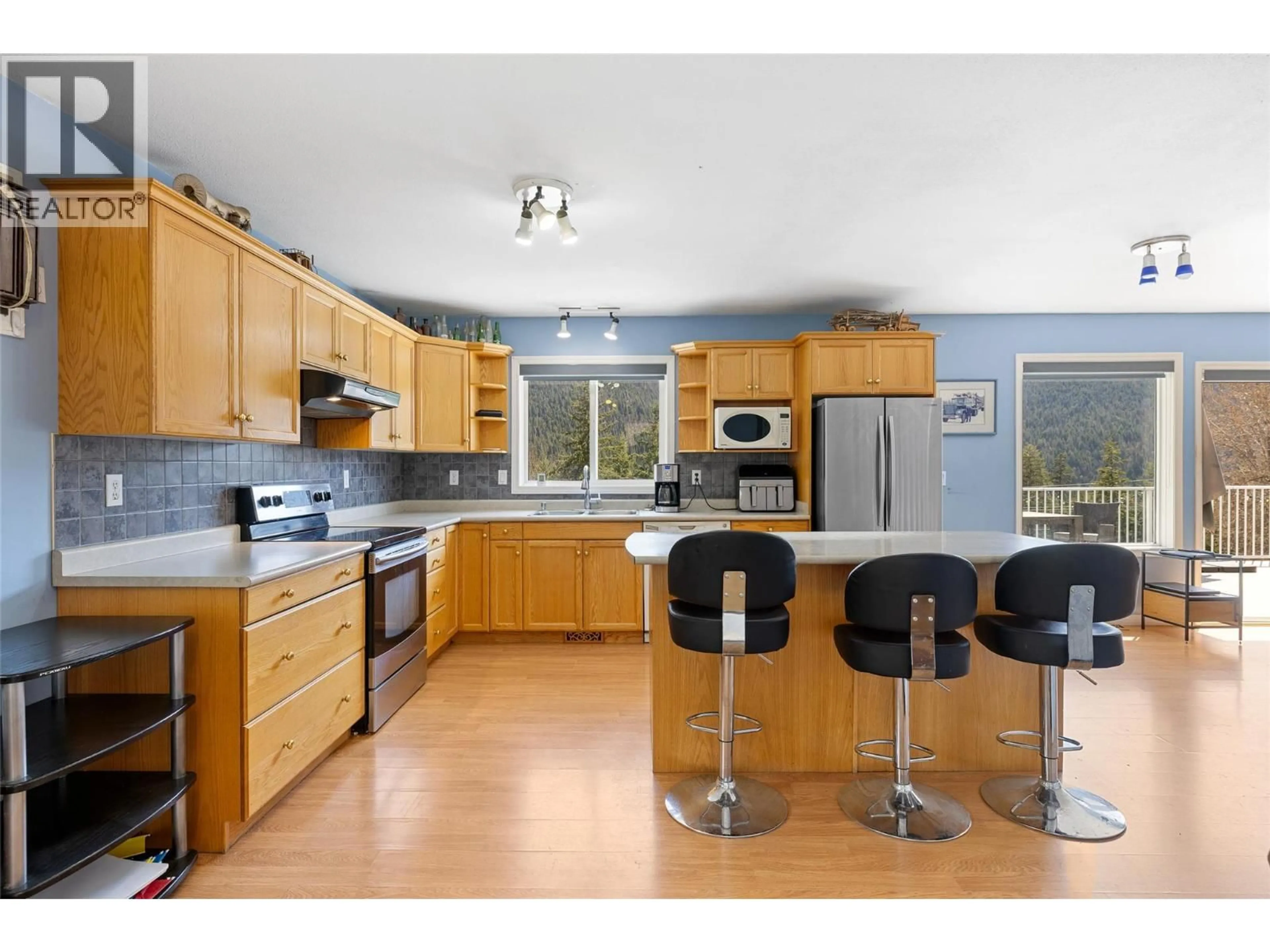 Open concept kitchen, wood/laminate floor for 7114 GOSHAWK ROAD, Kelowna British Columbia V1P1H9