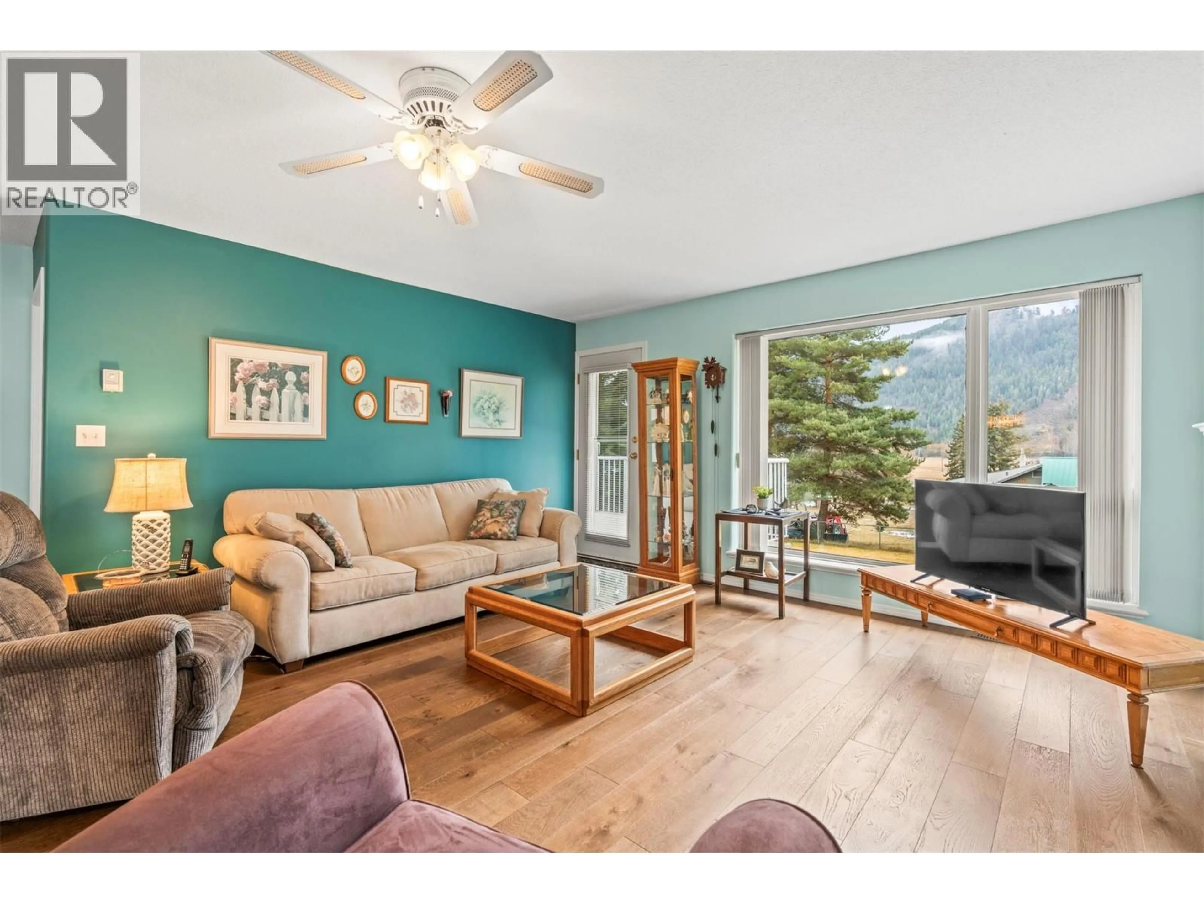 Living room with furniture, wood/laminate floor for 55 - 2675 PINE AVENUE, Lumby British Columbia V0E2G5